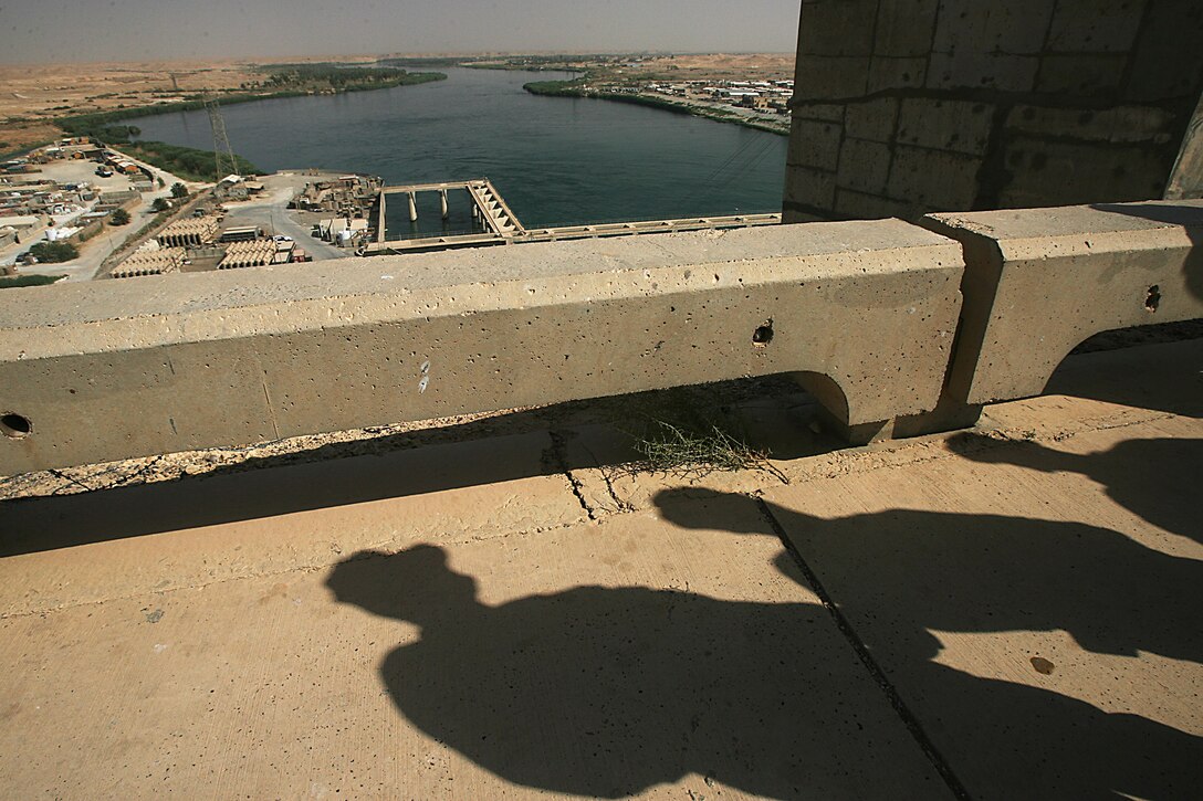 HADITHA DAM, Iraq (Aug. 15, 2008) – Leaders from Combat Logistics Battalion 6, 1st Marine Logistics Group, stand atop Haditha Dam during a tour of the area Aug. 15 discussing the future of the dam. With retrograde nearing completion, and the dam running under Iraqi supervision with minimal help from a detachment from the Army Corps of Engineers, 100 percent turnover is just over the horizon. (Photo by Cpl. GP Ingersoll)
