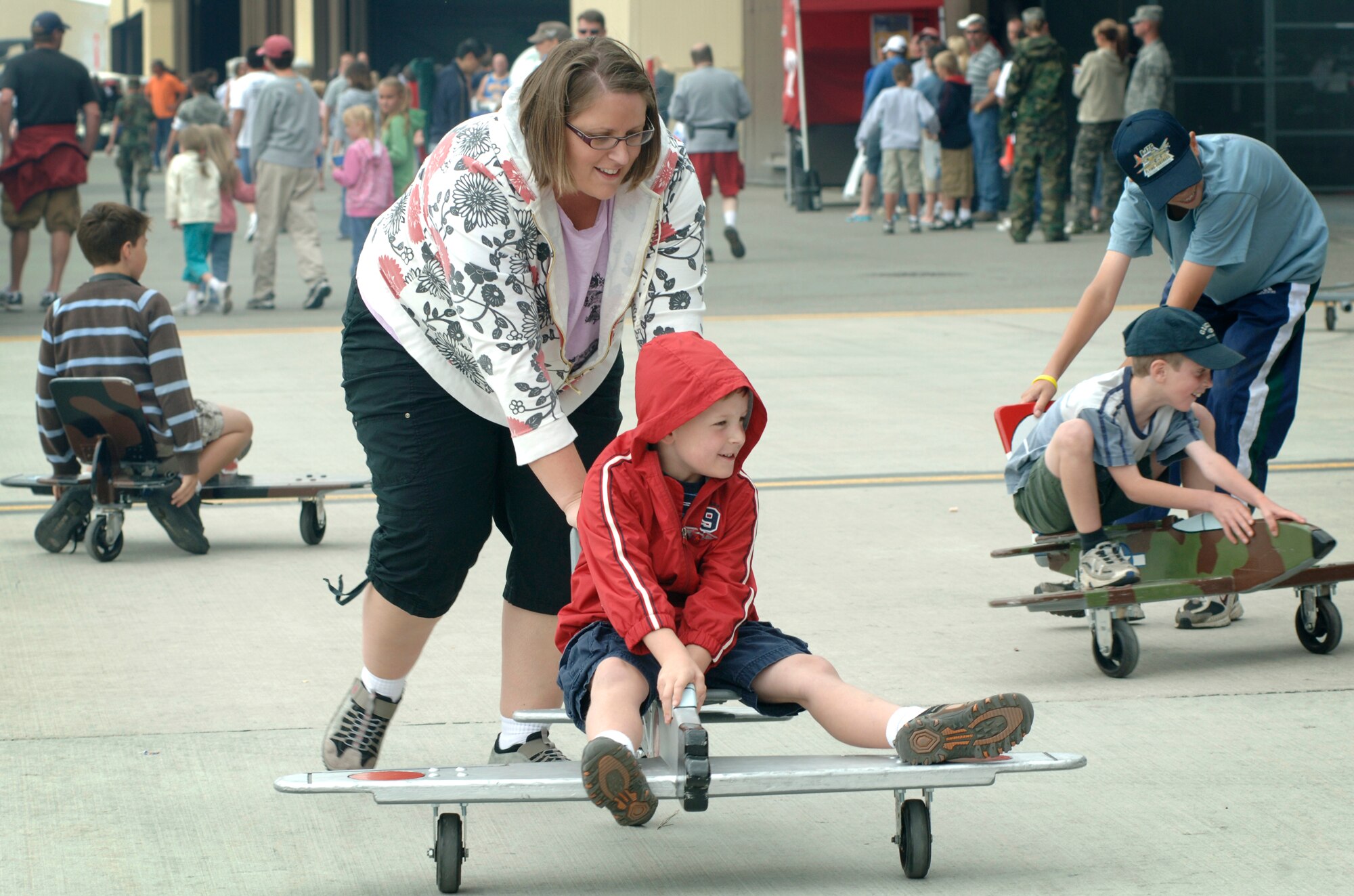 FAIRCHILD AIR FORCE BASE, Wash. – Children pretend to be aircraft pilots on small wooden model planes during the 2008 Skyfest airshow, Fairchild’s open house and airshow, here Aug. 10. (U.S. Air Force photo / Airman 1st Class Melissa Barnett)