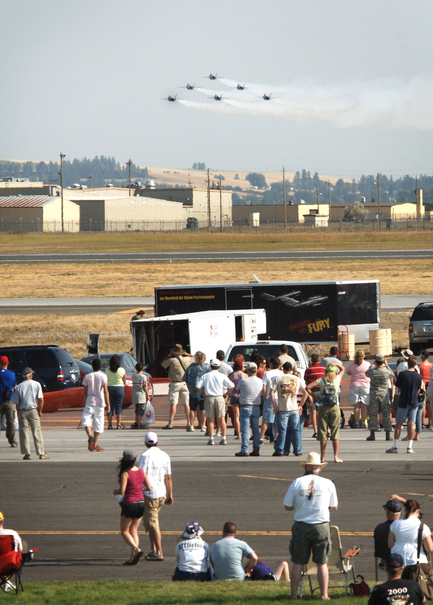 FAIRCHILD AIR FORCE BASE, Wash. – A small crowd watches as the Blue Angels scream toward them in a triangular formation here Aug. 10. The Blue Angels performed precision acrobatics through the Spokane County, Wash., skies during Fairchild’s open house and airshow, Skyfest 2008. (U.S. Air Force photo / Airman 1st Melissa Barnett)