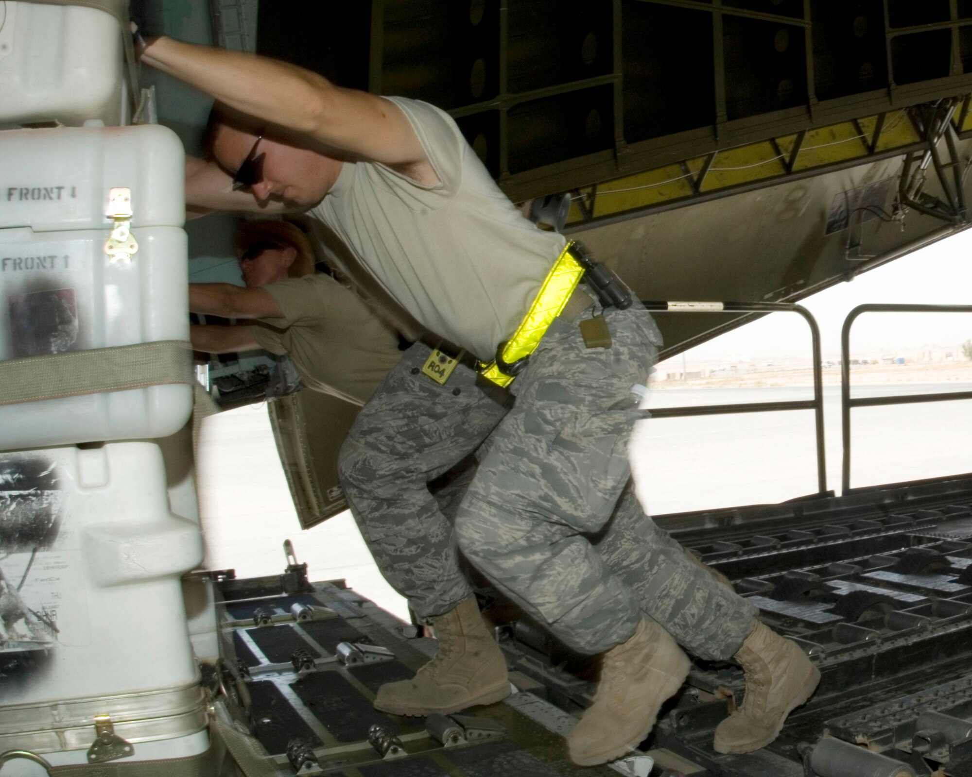 JOINT BASE BALAD, Iraq -- (Left to right) Master Sgt Laura Cerrantes and Senior Airman Aaron Ray push a pallet of equipment off a K-loader onto a C-5 Galaxy cargo aircraft here Aug. 16. Sergeant Cerrantes and Airman Ray are deployed to the 332nd Expeditionary Logistics Readiness Squadron from Travis Air Force Base, Calif. Airman Ray?s hometown is Vacaville, Calif. (U.S. Air Force photo/Tech Sgt Erik Gudmundson)