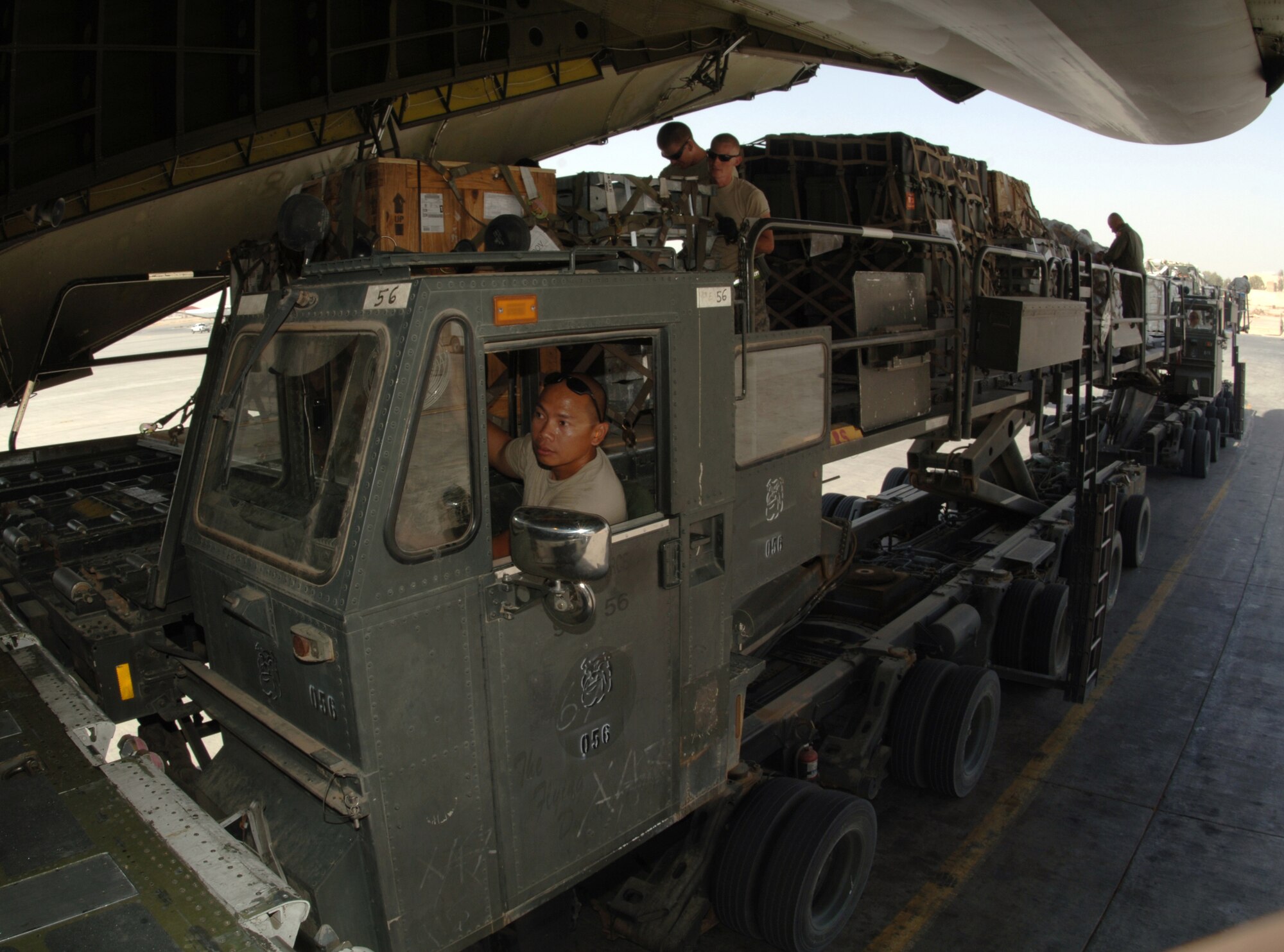 JOINT BASE BALAD, Iraq -- Airmen with the 332nd Expeditionary Logistics Readiness Squadron here offload cargo from a C-5 Galaxy onto a K-loader here Aug. 16. The Galaxy is the largest cargo aircraft in the Air Force inventory and one of the largest in the world, with the ability to carry up to 270,000 pounds of cargo. Airmen with the 332nd ELRS process more than 950 aircraft, 240,000 pounds of cargo and 19,000 passengers per month, making Joint Base Balad, Iraq, the busiest aerial port operation in the Department of Defense. (U.S. Air Force photo/Tech. Sgt. Erik Gudmundson)