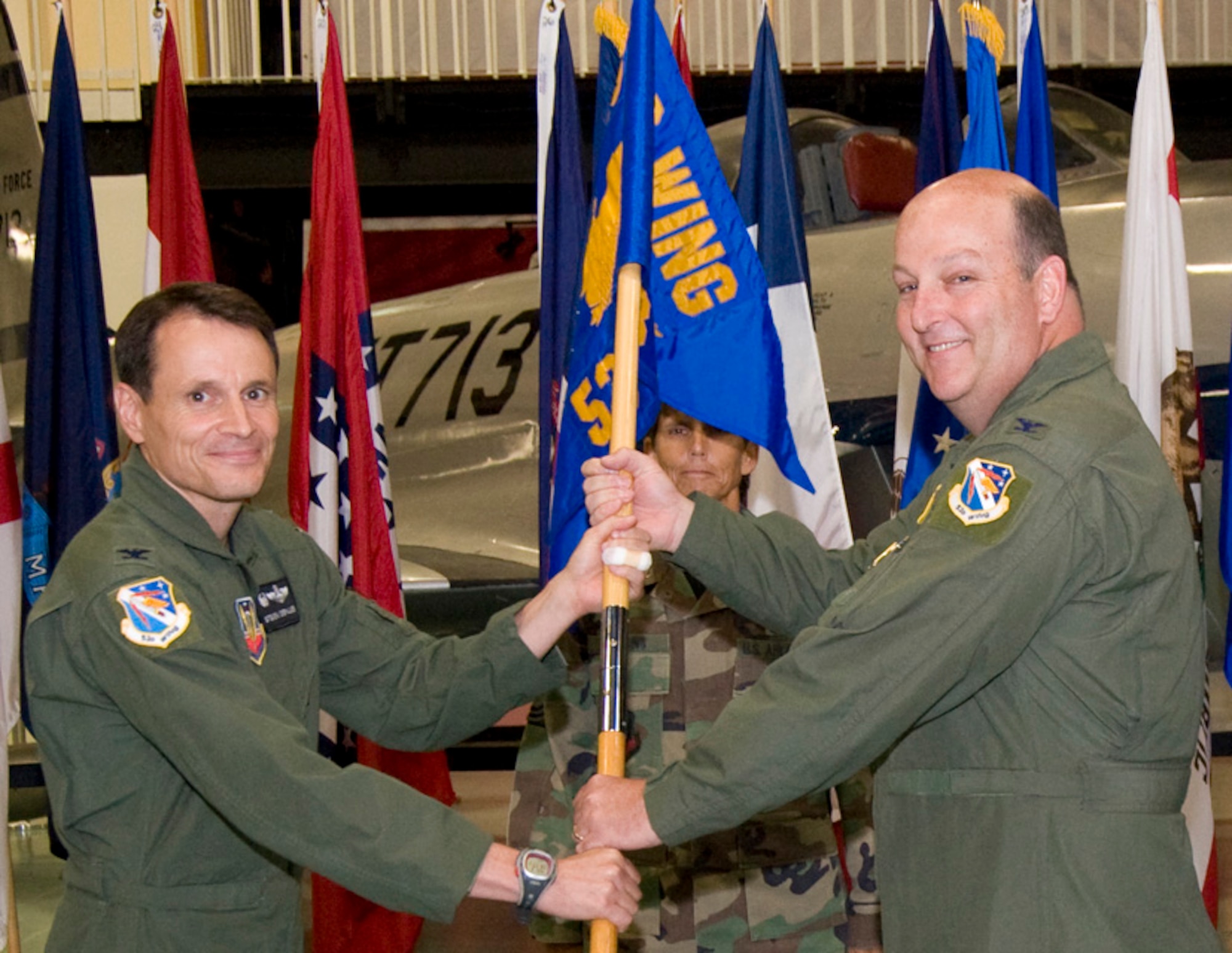 Col. Christopher Monahan, accepts the guidon from Col. Steve DePalmer, 53d Wing Commander, to take command of the 53d Test Management Group at a ceremony Aug. 8 at the Air Armament Museum.  Colonel Monahan is no stranger to the 53d Wing, he has also served as 53d Wing safety chief and commander of the 28th Test and Evaluation Squadron.  U.S. Air Force photo.
