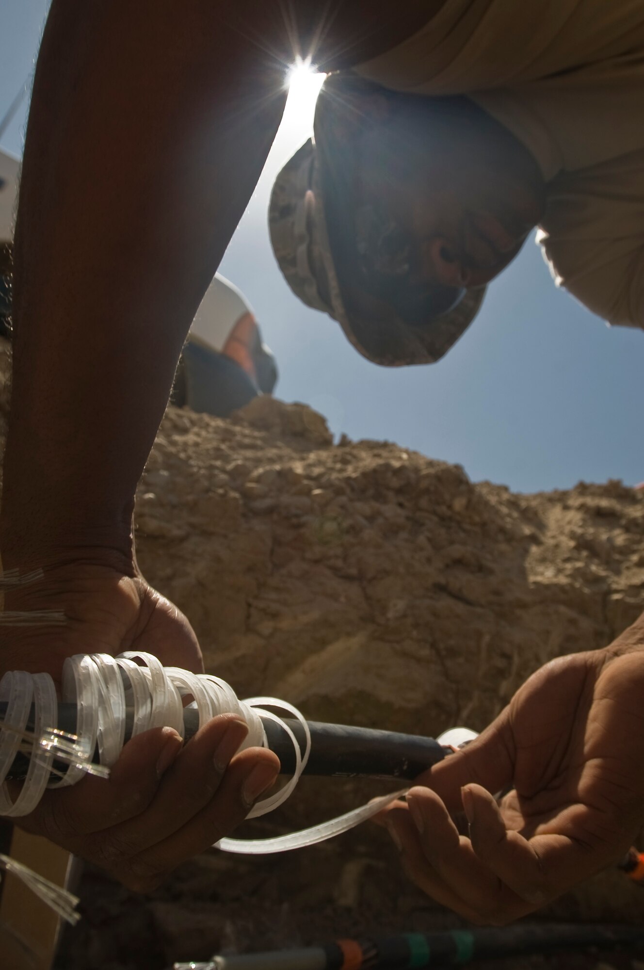 ALI BASE, Iraq -- Staff Sgt. Thee Thorpe, 407th Expeditionary Civil Engineer Squadron electrical systems journeyman, prepares to wrap a distribution line Aug. 15, 2008. Airmen of the 407th ECES are rerouting a power supply line that will soon feed the new mini base exchange here. Once complete, the BX will open and allow the entire base populace the opportunity to shop at two locations instead of just one. Sergeant Thorpe is deployed from F.E. Warren Air Force Base, Wyo. (U.S. Air Force photo/Airman 1st Class Christopher Griffin)