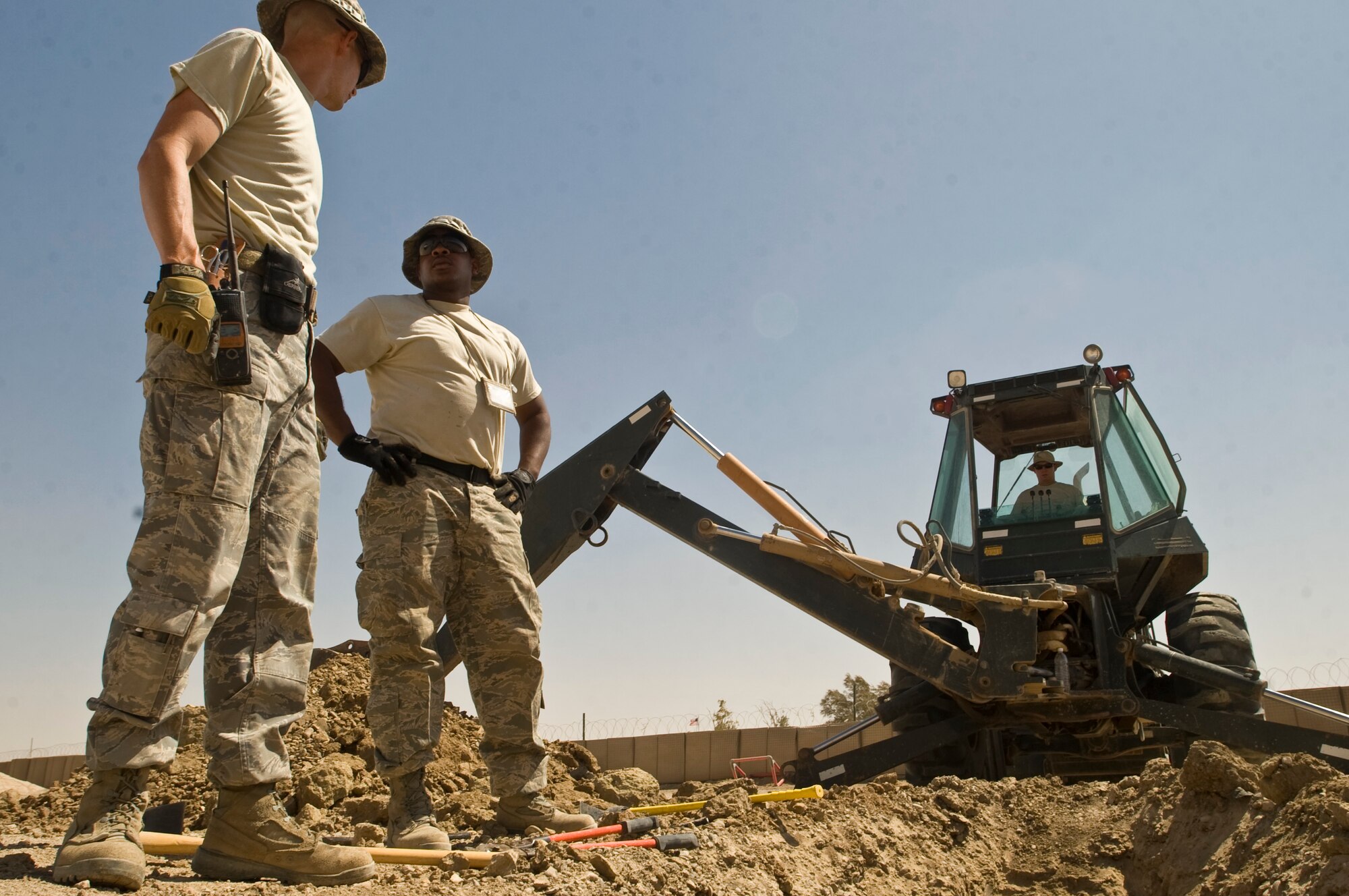 ALI BASE, Iraq -- Tech. Sgt. Clayton Schoepflin, electrical systems craftsman, and Staff Sgt. Thee Thorpe, electrical systems journeyman, evaluate where to set the Secondary Power Distribution Center Aug. 14, 2008. The sergeants and other Airmen assigned to the 407th Expeditionary Civil Engineer Squadron are rerouting a power supply line that will soon feed the new mini base exchange here. Once complete, the BX will open and allow the entire base populace the opportunity to shop at two locations instead of just one. Sergeant Schoepflin and Thorpe are deployed from F.E. Warren Air Force Base, Wyo. (U.S. Air Force photo/Airman 1st Class Christopher Griffin)
