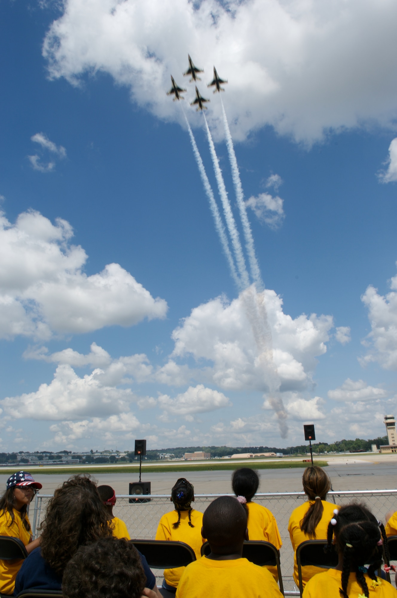 Children and special needs visitors watch a complete airshow that featured the Air Force Demonstration Squadron "Thunderbirds" Aug. 15 at Offutt Air Force Base, Neb. (U.S. Air Force photo/Lance Cheung)