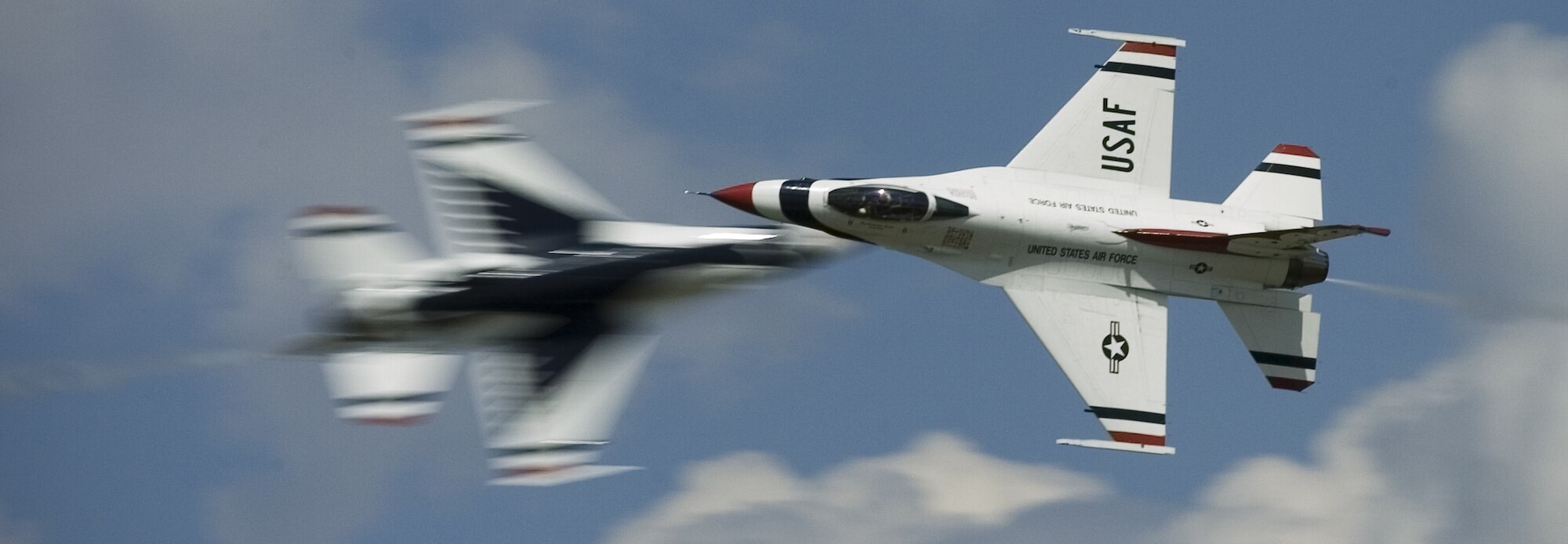 Pilots of the Air Force Demonstration Squadron "Thunderbirds" perform a knife-edge pass during the special needs airshow Aug. 15 at Offutt Air Force Base, Neb. (U.S. Air Force photo/Lance Cheung)