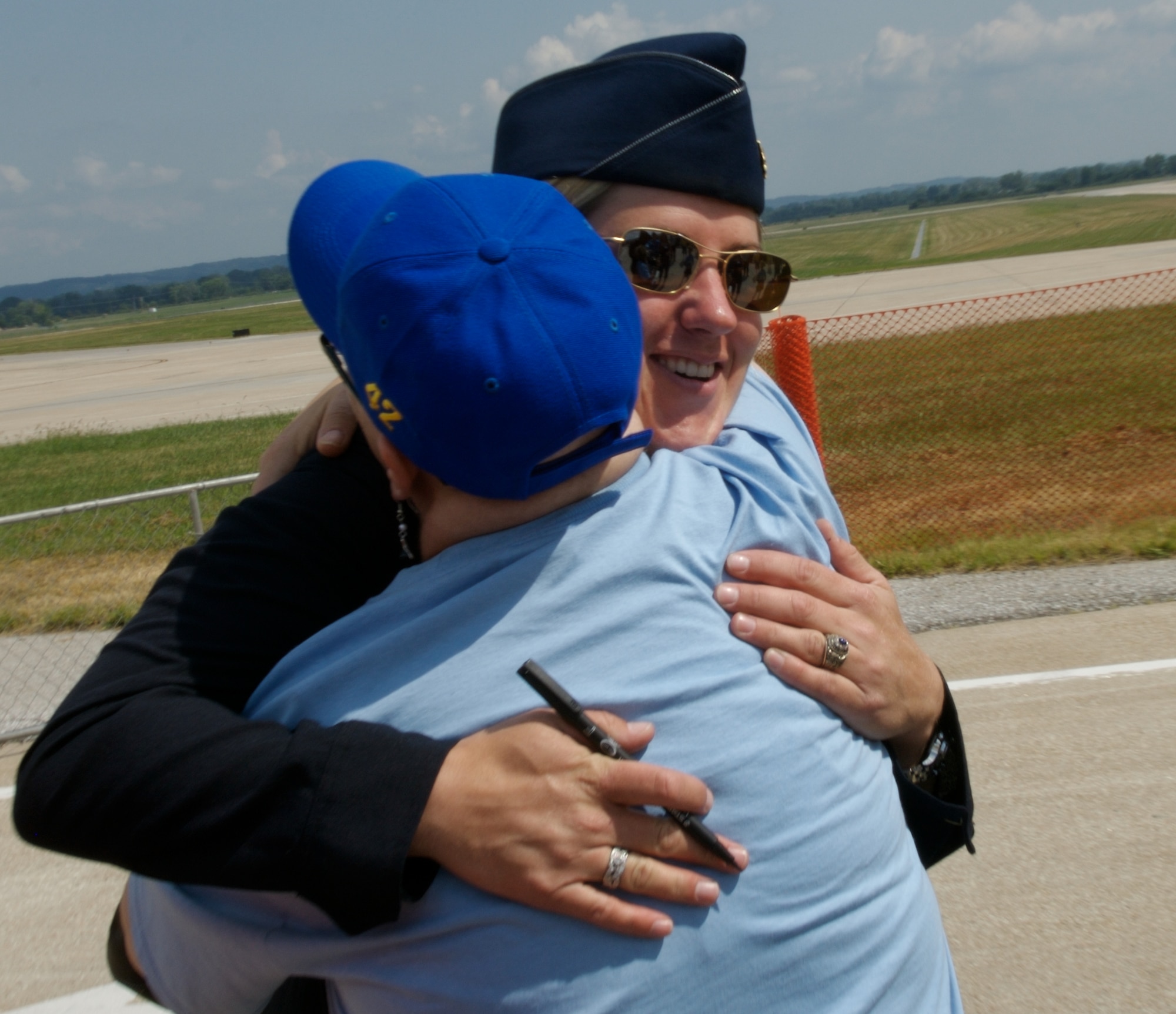 Maj. Samantha Weeks provides more than an autograph when a fan gives her a hug during a special needs airshow Aug. 15 at Offutt Air Force Base, Neb.  Major Weeks is with the Air Force Demonstration Squadron, "Thunderbirds," and flies the No. 5 jet as the lead solo pilot.  (U.S. Air Force photo/Lance Cheung)  