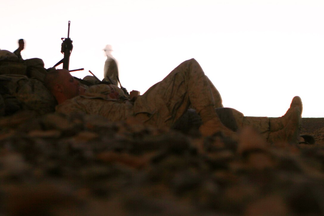 Marines with Fox Company, Battalion Landing Team 2/5, 15th Marine Expeditionary Unit, rest after a day of training during the bi-lateral training exercise "Infinite Moonlight" in the Jordanian desert.::r::::n::   Infinite Moonlight, a two-week exercise conducted by the U.S. military and the Jordanian Army, is designed to share tactical knowledge and build on the military ties between the United States and Jordan.::r::::n::   The Camp Pendleton, Calif. based 15th MEU is comprised of approximately 2,200 Marines and Sailors and is a forward deployed force of readiness capable of conducting numerous operations, such as Non-Combatant Evacuation Operations, Humanitarian Assistance Operations and a wide range of amphibious missions. ::r::::n::   The 15th MEU is currently conducting sustainment training in the desert of Jordan. (Official USMC photo by Cpl. Timothy T. Parish) (Released)::r::::n::