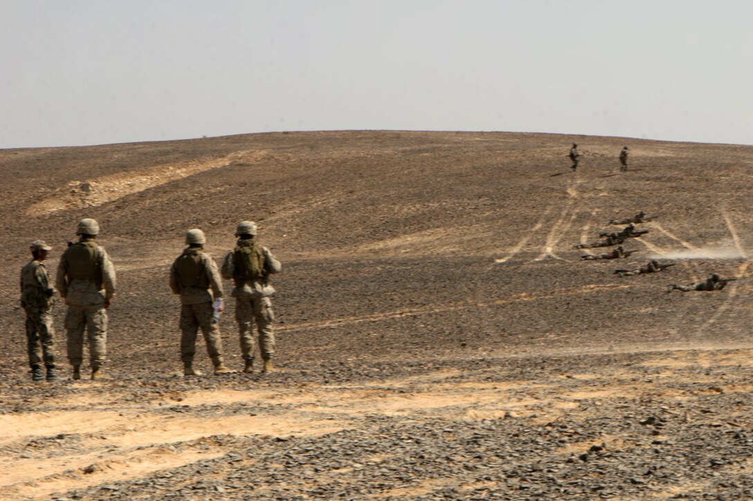 Marines with Fox Company, Battalion Landing Team 2/5, 15th Marine Expeditionary Unit, watch as Jordanian soldiers conduct a security patrol during the bi-lateral training exercise "Infinite Moonlight" in the Jordanian desert.::r::::n::   Infinite Moonlight, a two-week exercise conducted by the U.S. military and the Jordanian Army, is designed to share tactical knowledge and build on the military ties between the United States and Jordan.::r::::n::   The Camp Pendleton, Calif. based 15th MEU is comprised of approximately 2,200 Marines and Sailors and is a forward deployed force of readiness capable of conducting numerous operations, such as Non-Combatant Evacuation Operations, Humanitarian Assistance Operations and a wide range of amphibious missions. ::r::::n::   The 15th MEU is currently conducting sustainment training in the desert of Jordan. (Official USMC photo by Cpl. Timothy T. Parish) (Released)::r::::n::