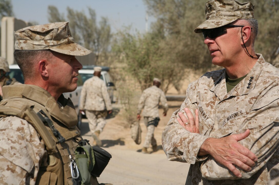 General James T. Conway, Commandant of the Marine Corps, speaks with Col. Lewis A. Craparotta, commanding officer, Regimental Combat Team 1, during a visit to Camp Fallujah, Iraq, Aug. 16. During his visit, the Commandant evaluated progress being made in al-Anbar and discussed security with several members of the Iraqi Army. He also took time to speak with service members at the Chapel of Hope aboard the camp. (Official Marine Corps photo by Cpl. Chris T. Mann)