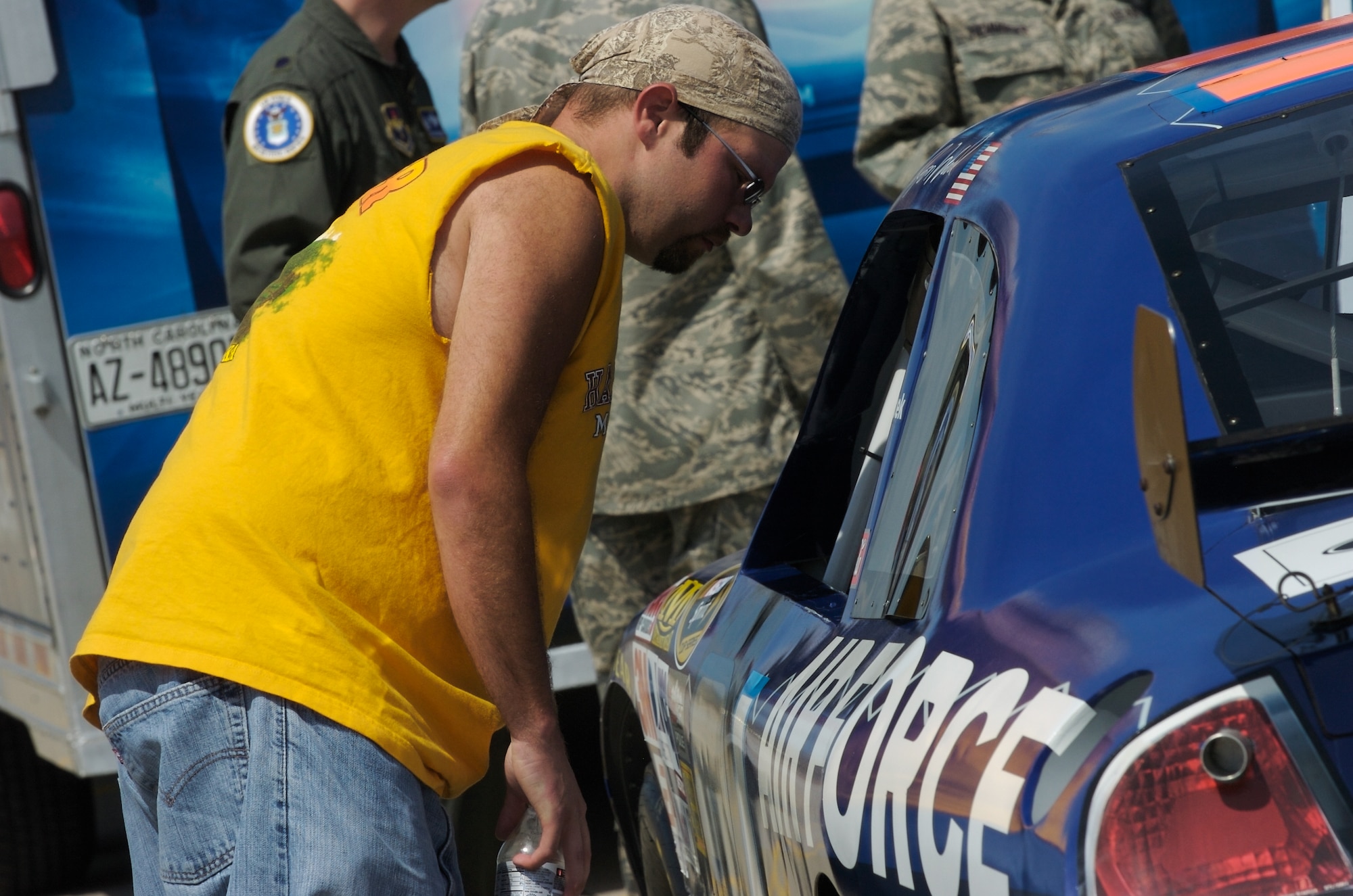 Joe Morgan takes a look into the Woods Brothers No. 21 Air Force Ford Fusion on display at the Dillon Brothers Harley-Davidson for Air Force Week in the Heartland Aug. 14 in Omaha, Neb. The race car and the Air Force Orange County Chopper were on display. Mr. Morgan is a resident of Arlington, Neb. (U.S. Air Force photo/Lance Cheung)
