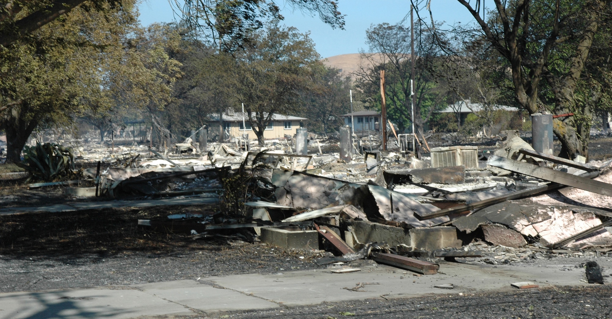 An eight-alarm fire that spread to Travis Air Force Base destroyed 167 unoccupied housing units  and damaged 11 more Aug. 16 . Travis emergency personnel, with help from local firefighting and police agencies, contained the fire before it spread to any occupied housing on the base. (U.S. Air Force photo/Senior Airman Shaun Emery)