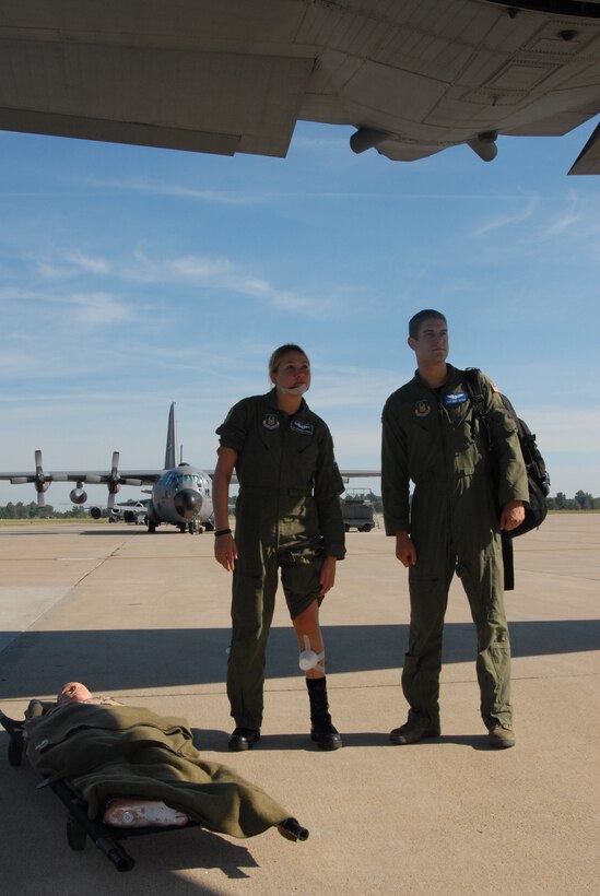 This is only pretend...as several Air Force Reservists came out to play the part of simulated "patients" in the Aeromedical Evacuation JAMBOREE training event held at Scott Air Force Base.  They boarded a C-130 from the 934th Airlift Wing (Minneapolis, Minn.) and flew several hours to train medically in the air.  At left is Senior Airman Morgan Strong from the 349th Air Mobility Wing (Travis Air Force Base, Calif.) and Staff Sgt. David Counts from the local 932nd Airlift Wing at Scott AFB.  (U.S. Air Force photo by Maj. Stan Paregien)