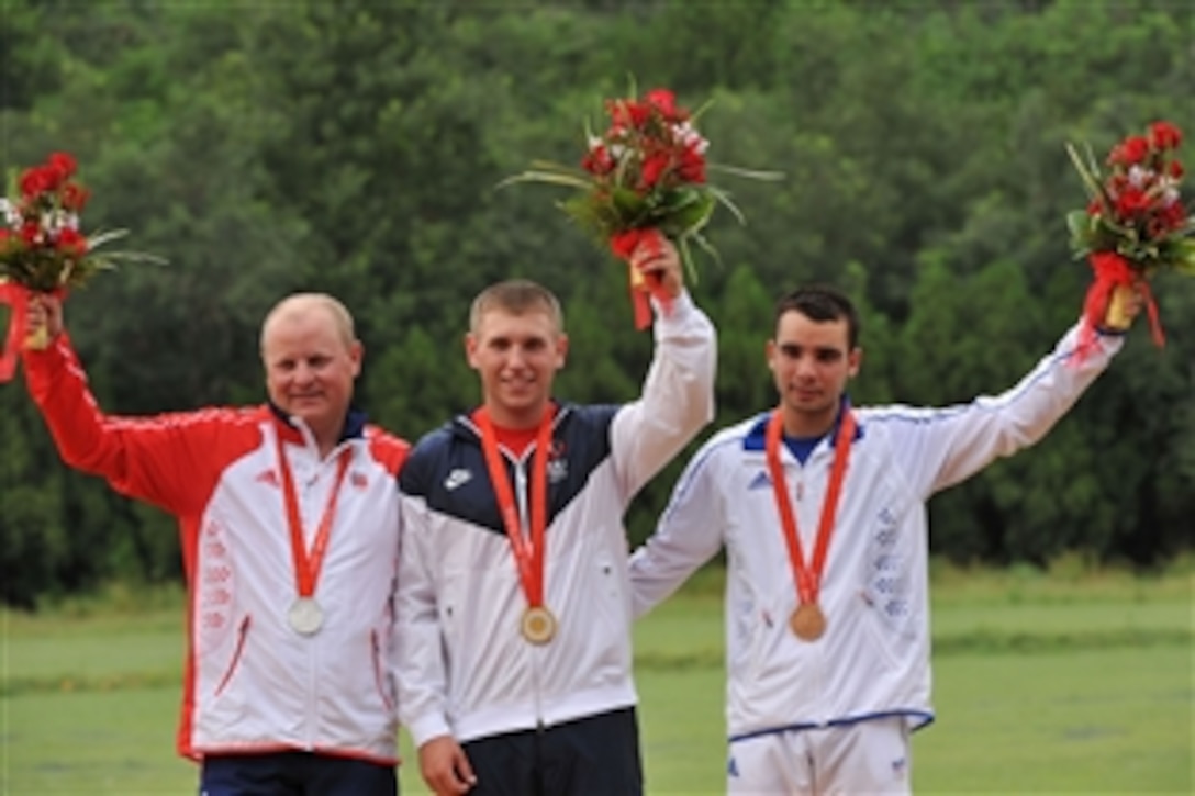 Olympic skeet gold medal winner Pfc. Vincent Hancock, center, of the U.S. Army Marksmanship Unit, is flanked by silver medalist Tore Bovold, left, of Norway and bronze medalist Anthony Terras, right, of Italy on the podium, Aug. 16, 2008, in Beijing. 
