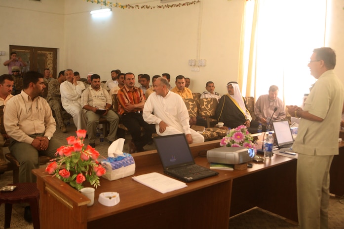 Key leaders from around western Al Anbar province discuss a variety of topics about directing a local government during a government training class held in Rutbah, Iraq, Aug. 18. During the event, the leaders gathered to learn several key elements from government structure to requirements of a well-assembled city council.::r::::n::