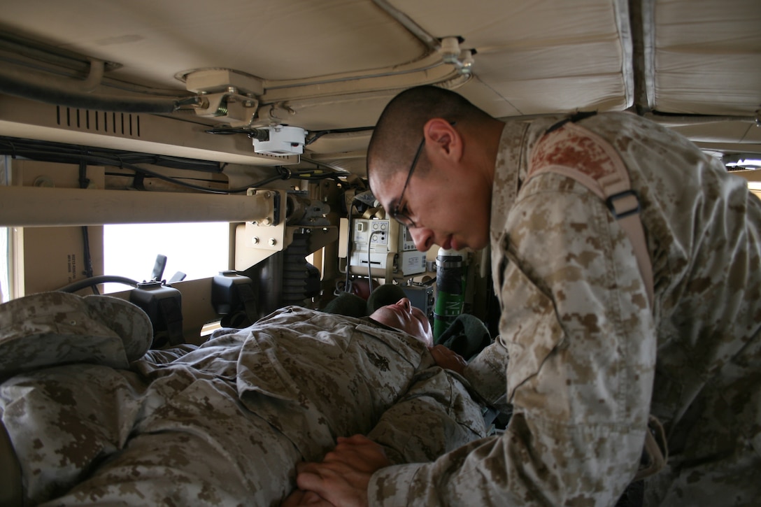 Petty officer 3rd Class Joshua Martinez, a corpsman with Task Force 2nd Battalion, 2nd Marines, Regimental Combat Team 5, checks the vital signs of a simulated casualty at Camp Al Qaâ??Im, Iraq, August 15. The new Mine Resistant Ambush Protected Ambulance is one of nine manufactured for use by corpsmen in combat zones. The MRAP Ambulance contains various medical equipment corpsmen would use to treat a variety of injuries.
