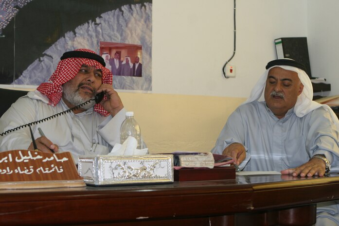 Hamid Khalid Ibrahim (left), the mayor of Rawah, Iraq, sits with one of his city council members Aug. 15 during a meeting with the company commander of Company F, Task Force 2nd Battalion, 2nd Marine Regiment, Regimental Combat Team 5. One topic discussed was the recent return of the Rawah Iraqi Police Station to the authority of the city of Rawah after Marines operated from it, in conjunction with the Iraqi Police, for nearly three years.