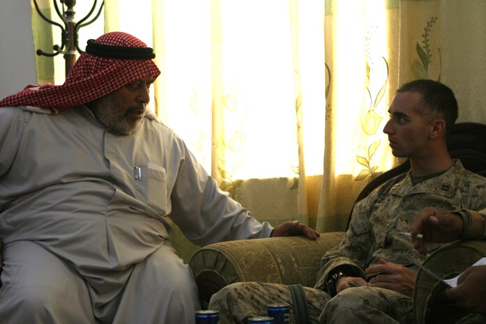 Hamid Khalid Ibrahim, the mayor of Rawah, and Capt. Aaron Schwartz, the company commander of Company F, Task Force 2nd Battalion, 2nd Marine Regiment, Regimental Combat Team 5, discuss various issues pertaining to the city of Rawah, Iraq, August 17. â??Slowly the city of Rawah is progressing,â?? said Schwartz. â??Elected officials are beginning to work toward solving the problems of essential services and economics. Each day Rawah makes small gains toward complete self reliance.â??