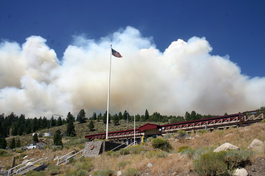 Smoke blows behind the Command Post of Marine Corps Mountain Warfare Training Center in Bridgeport, Calif., Aug. 18, 2008.The fire, started by lightning, burned 680 acres of land before it was contained.