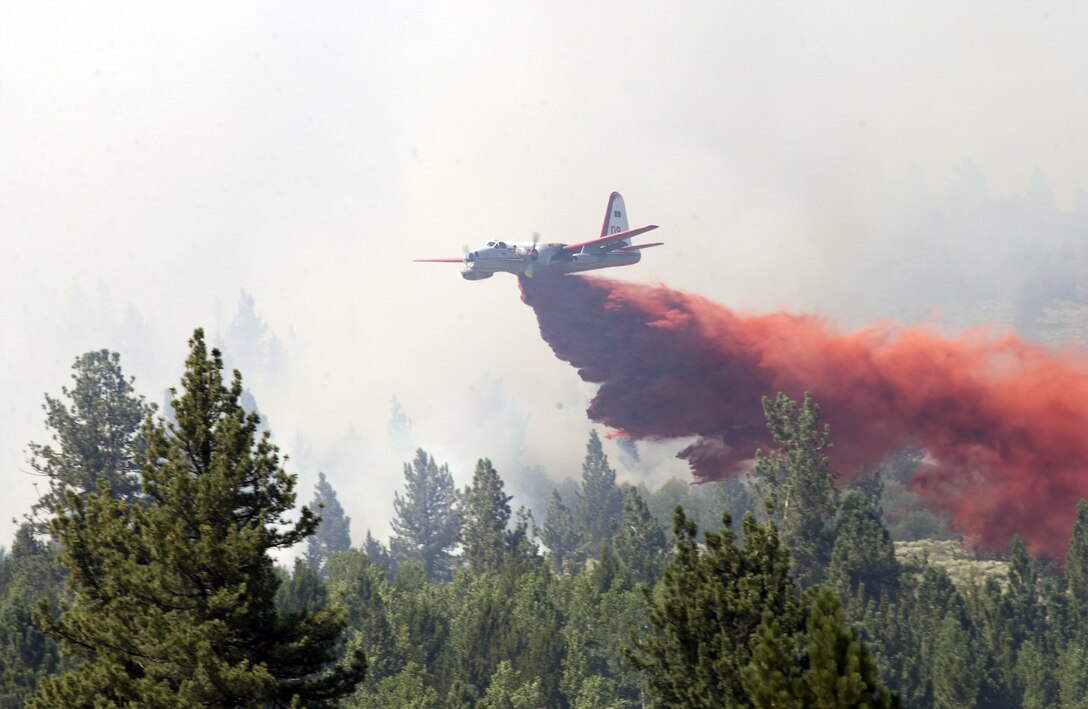 A P-2V Neptune drops retardant on the training grounds of Marine Corps Mountain Warfare Training Center in Bridgeport, Calif., during firefighting efforts on Aug. 18, 2008. The fire, started by lightning, burned 680 acres of land before it was contained.
