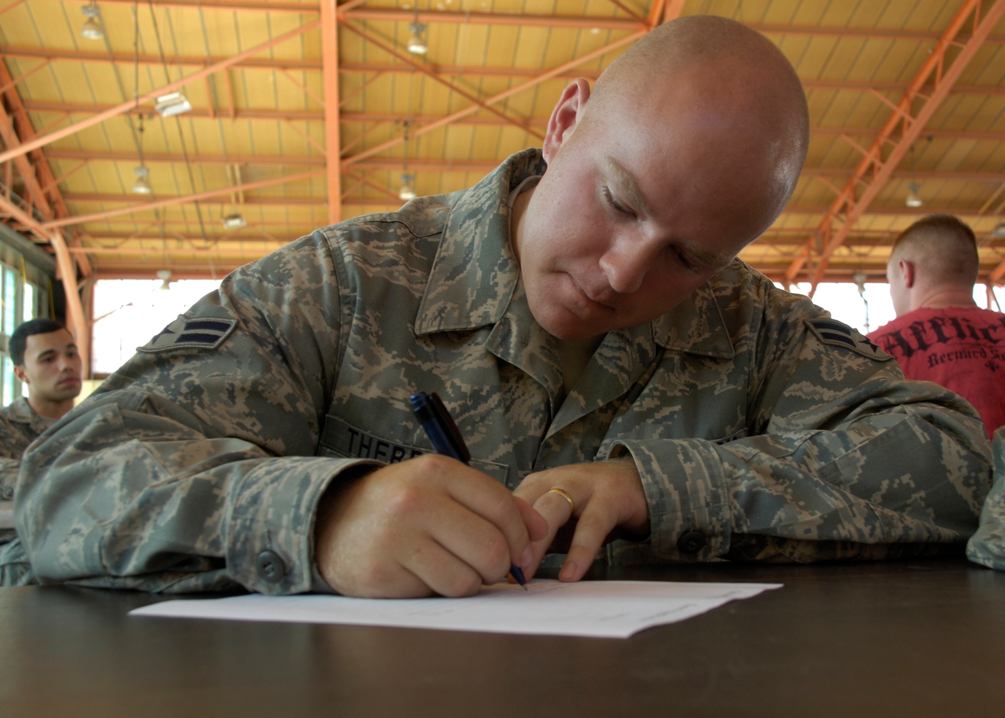 Airman 1st Class Matthew Therrell, 49th Materiel Maintenance Support Squadron, fills out an application to play an extra for a Dream Works Pictures feature film during a casting call at Holloman AFB, N.M., August 15. Approximately 300 Airmen from Holloman participated in the casting call. (U.S. Air Force photo/Airman 1st Class Michael Means)