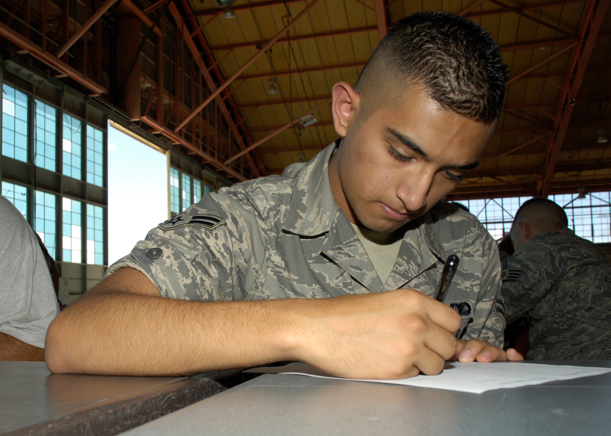 Airman 1st Class Jesus Lerma-Padilla, 49th Operations Group, fills out an application to play an extra for a Dream Works Pictures feature film during a casting call at Holloman AFB, N.M., August 15. Dream Works came to Holloman to shoot scenes for an unnamed feature film. Approximately 300 Airmen from Holloman participated in the casting call. (U.S. Air Force photo/Airman 1st Class Michael Means)