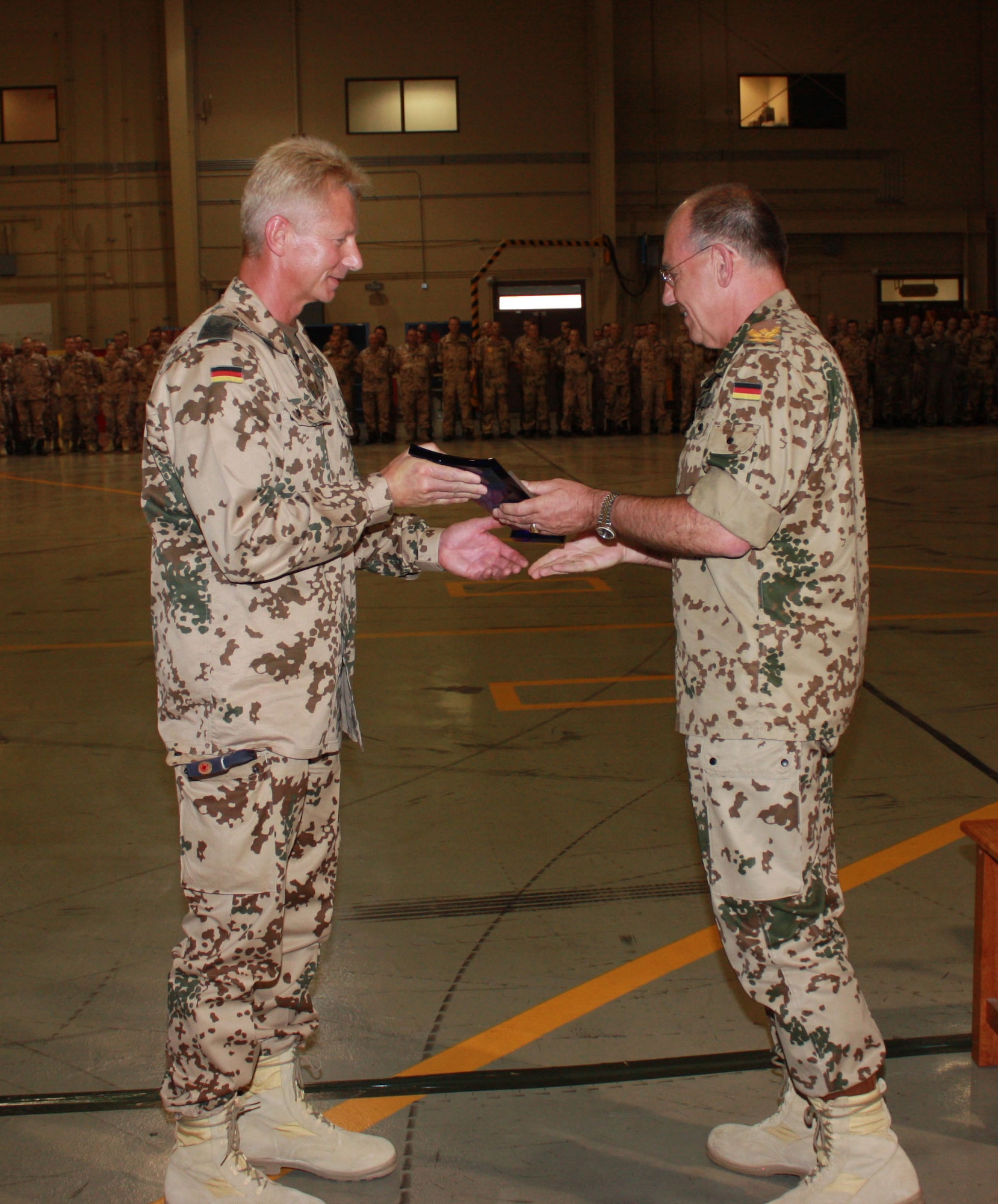 Brig. Gen. Gero L.K. Shachthofer, German air force commander German Armed Forces Command United States and Canada, presents Col. Peter Klement, German Air Force Flying Training Center commander, with a Flight Safety Cup at Holloman Air Force Base, N.M., August 14. The Flight Safety Cup was rewarded to the German Air Force Flying Training Center for five years without a flight accident. (German Air Force photo/Chief Master Sgt. Robert Meintz)