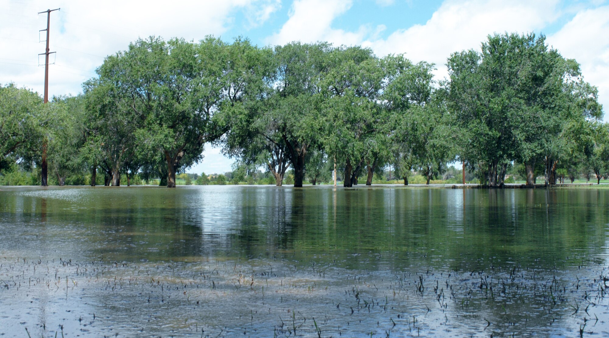 CANNON AIR FORCE BASE N.M. -- Water turned Whispering Winds Golf Course into a lake, following 3.62 inches of rain Aug. 15-17, forcing closure of the course.  The 27th Special Operations Civil Engineer Operations Flight began pumping 400 gallons of water per minute out of the golf course Aug. 18. The course will remain closed until the water is removed and the grass dries.  (U.S. Air Force photo by Airman 1st Class James R. Bell)