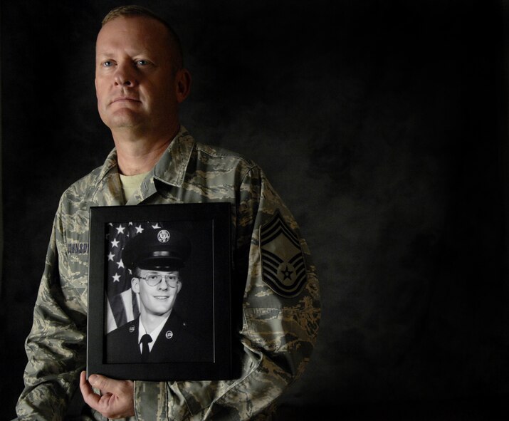 MOODY AIR FORCE BASE, Ga. -- Chief Master Sgt. Andrew Johnson, 723rd Aircraft Maintenance Squadron, retires Aug. 15 after 30 years of service in the Air Force. Sergeant Johnson holds an official photo of himself that was taken when he first entered the Air Force in 1978. (U.S. Air Force photo by Senior Airman Javier Cruz Jr)