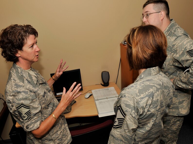 MOODY AIR FORCE BASE, Ga -- Senior Master Sgt. Andrea Gates, Air Combat Command inspection team member, inspects the client support administrator training program with Senior Master Sgt. Lisa Friend, 23rd Communications Squadron superintendent of plans and resources flight, and Tech. Sgt. Andrew Neal, 23rd CS NCO in-charge CSA training, on the first day of the ACC Unit Compliance Inspection here Aug. 18. (U.S. photo by Senior Airman Schelli Jones)