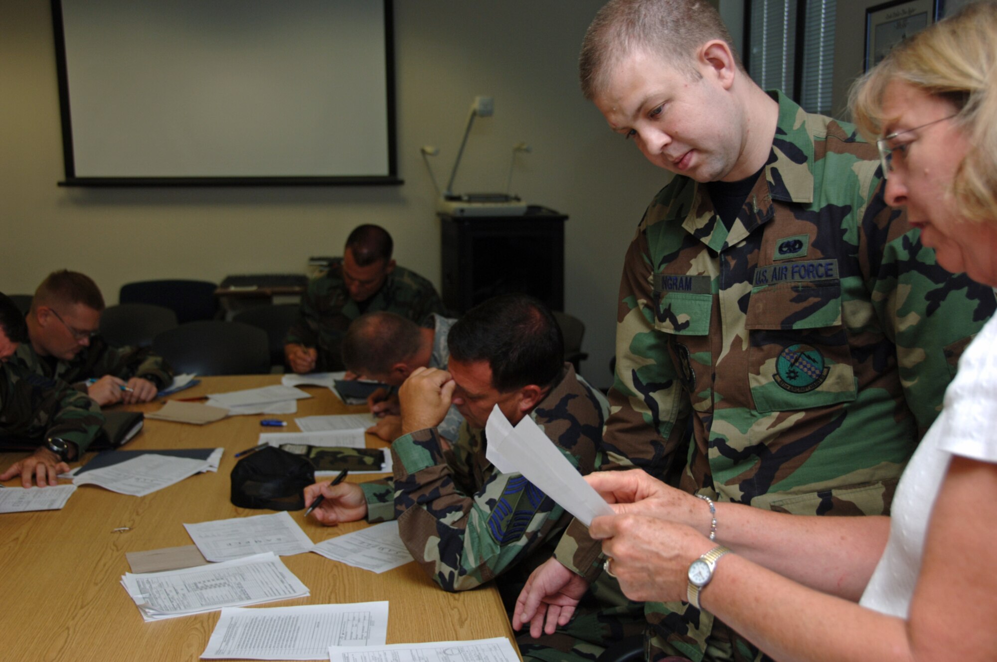 Senior Airman Brandon Ingram gets some paperwork help Monday morning from Mary Borst, 931st Air Refueling Group budget officer. Airman Ingram and other Airmen from the 931st Aircraft Maintenance Squadron returned to McConnell Air Force Base, Kan., late Sunday night from a deployment to Turkey. The squadron sent three, two-week rotations of personnel to Turkey in support of Operations Iraqi and Enduring Freedom. (U.S. Air Force photo/Tech. Sgt. Jason Schaap)