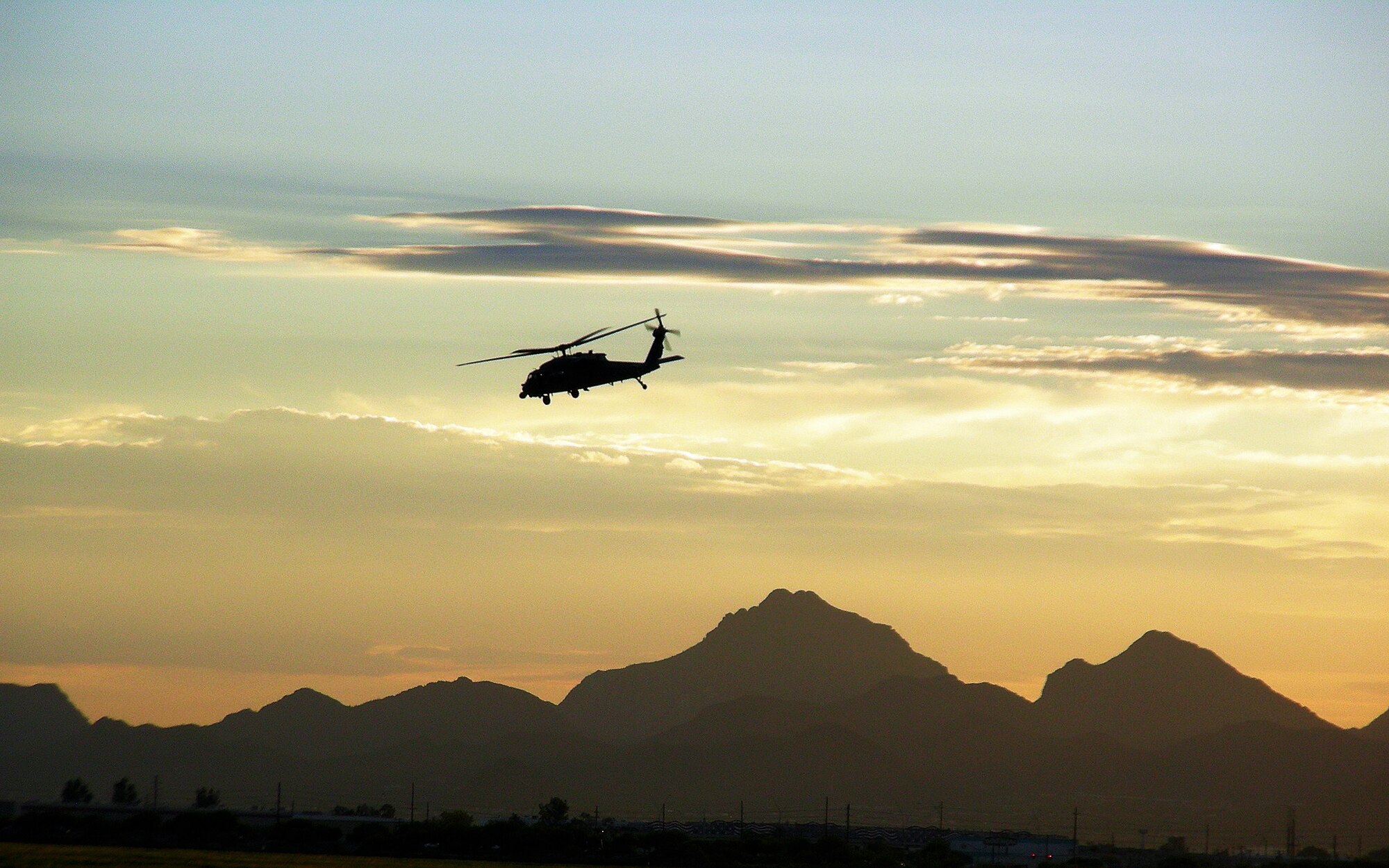 A 920th Rescue Wing HH-60G Pave Hawk helicopter  pierces the desert sky over the mountains in southern Arizona. Air Force Reserve Command aircrews and maintainers from Patrick Air Force Base, Fla., worked day and night July 12-25, 2008, at Davis-Monthan AFB, Ariz., to gain high-altitude experience prior to their upcoming deployment to Afghanistan. The country is known for having the roughest terrain with some of the highest mountains in the world. (U.S. Air Force photo/Capt. Cathleen Snow)