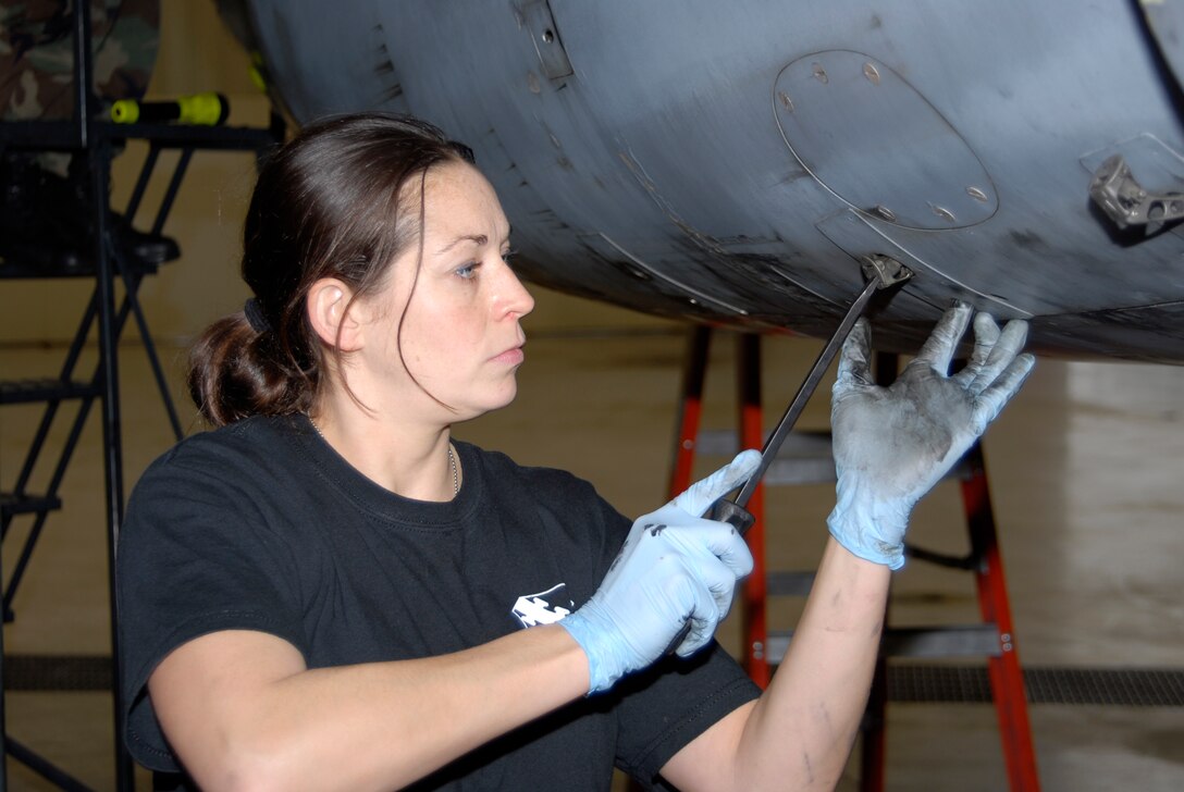 SCOTT AIR FORCE BASE, Ill. - Staff Sgt. Cari Perez, a crew chief with the 126th Aircraft Maintenance Squadron, replaces an engine cover on a KC-135E Stratotanker as it completes a 60 day regular maintenance cycle.  The 126 AMS is a part of the 126th Air Refueling Wing, Illinois Air National Guard, located at Scott Air Force Base, Ill. (U.S. Air Force photo by Master Sgt. Ken Stephens) (Released)