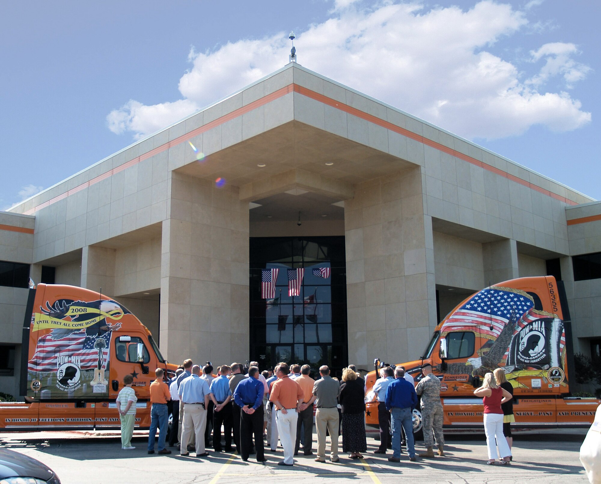 Employees of Schneider National, Inc., a trucking company headquartered in Green Bay, Wis.,  stand outside the headquarters July 1 for a ceremony marking the signing of a memorandum of understanding between Schneider and the Department of Veterans Affairs. (Courtesy photo)     