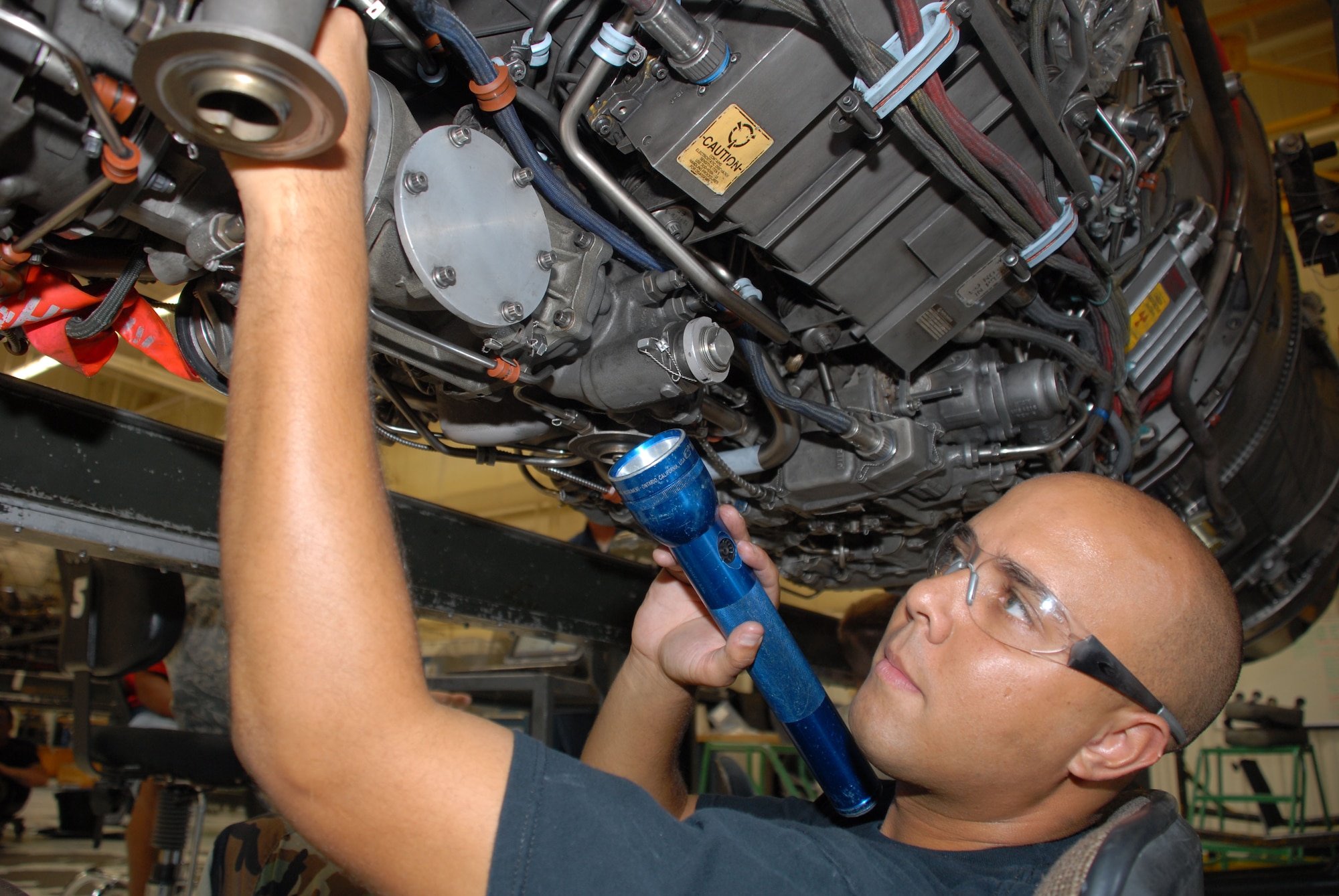 Staff Sgt. Joshua Garcia, 56th Component Maintenance Squadron engine mechanic, inspects the gearbox of a jet engine in the propulsion engine shop. (U.S. AIR FORCE PHOTO/ Airman 1st Class Tracie Forte.)
