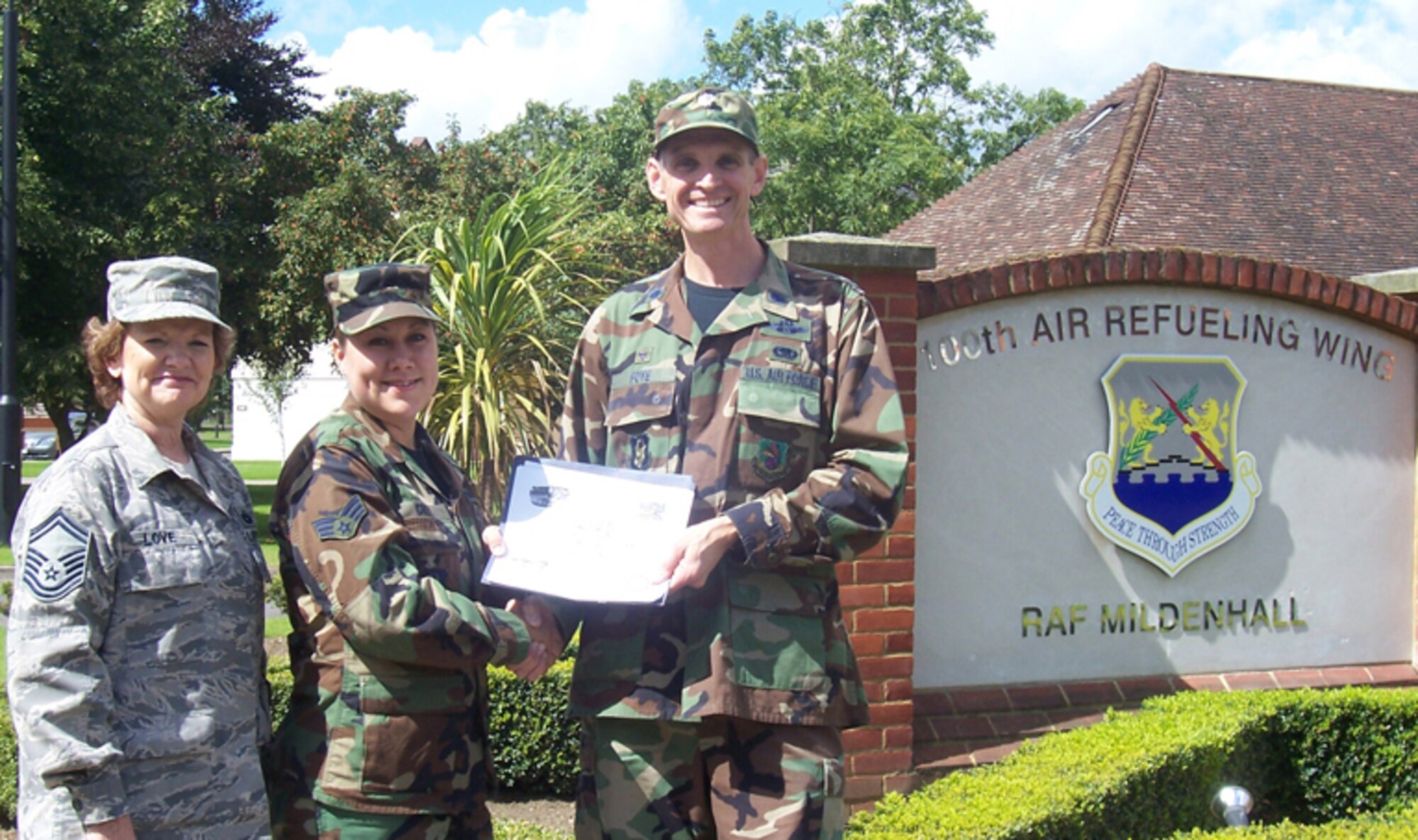GRISSOM AIR RESERVE BASE, Ind., -- Kimberly Grey (center), a vehicle operator with the 434th Logistics Readiness Squadron, is congratulated on her promotion to Senior Airman while deployed to RAF Mildenhall, England, by Lt. Col. Martin Foye, 434th LRS Commander, and SMSgt Ruth Love, 434th LRS Vehicle Operations Section Superintendent. While in England, 434th personnel integrated with the 100th LRS and supported NATO and local readiness exercises. The unit recently returned to Grissom ARB (U.S. Air Force photo)

