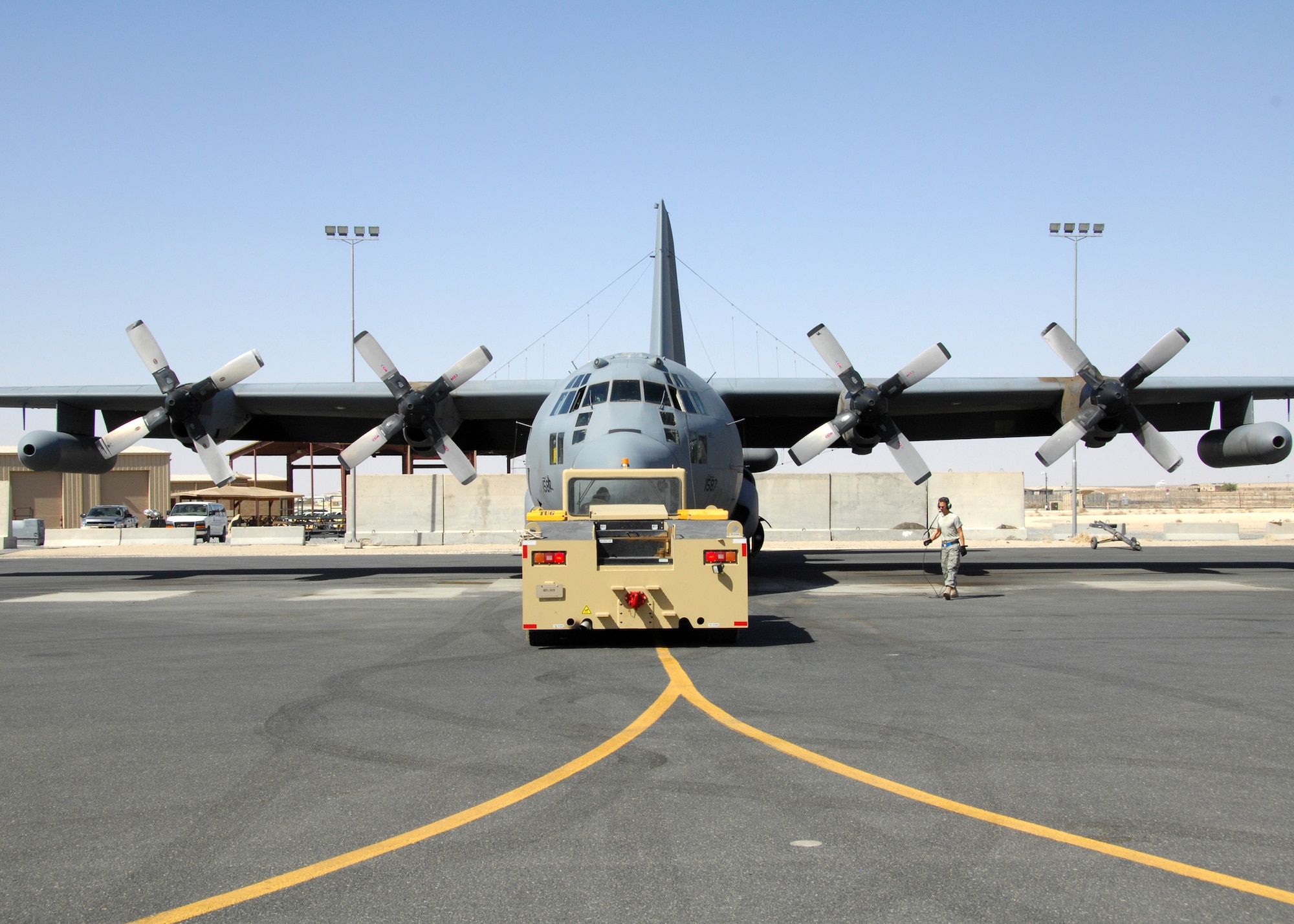 SOUTHWEST ASIA -- Members of the 386th Expeditionary Aircraft Maintenance Squadron guide an EC-130 Compass Call assigned to the 43rd Expeditionary Electronic Combat Squadron into its designated parking spot on Aug. 15 at an air base in Southwest Asia. The 43rd EECS just completed their 2,500th Operation Iraqi Freedom combat sortie. Since the squadron’s first Operation Iraqi Freedom deployment in March 2004, the 43rd EECS has flown more than 17,500 mishap free combat hours providing electronic combat coverage to coalition troops operating in the OIF theater of operations. (U.S. Air Force photo/Tech. Sgt. Raheem Moore)