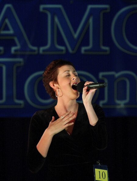 DOVER AIR FORCE BASE, Del. -- Airman 1st Class Naomi Nadeau, 436th Aircraft Maintenance Squadron, sings Whitney Houston’s "I Will Always Love You," during Dover’s Air Mobility Command Icon competition at The Landings Club Aug. 13. She won the contest and a $500 cash prize and will now compete at the AMC-level competition Oct. 23 for a $1,000 cash prize. (U.S. Air Force photo/Roland Balik) 