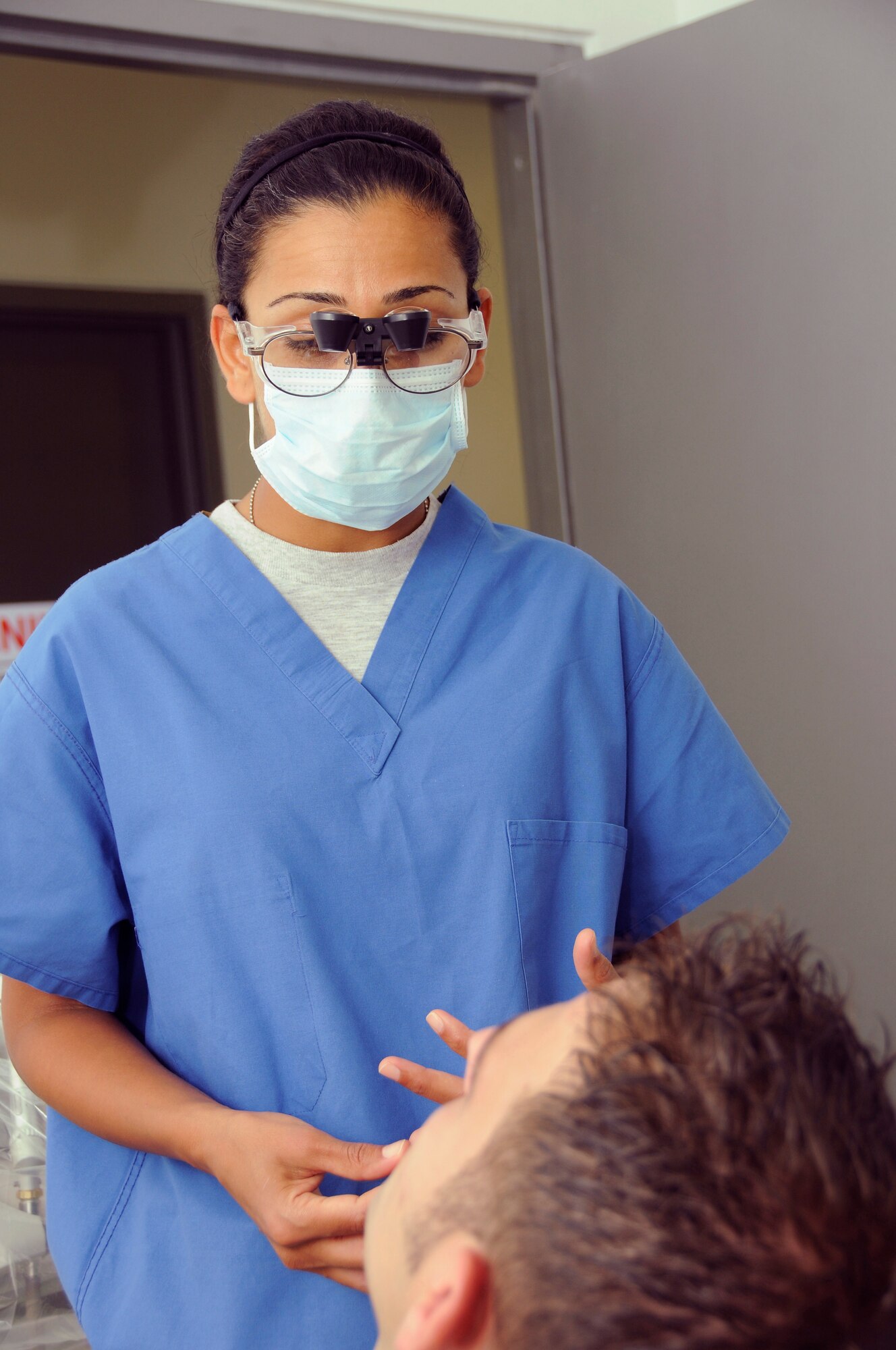 Capt. Humaira Masood, a dentist with the 379th Expeditionary Medical Group, explains her findings to Senior Aircraftsman Connal Jones, 901st Expeditionary Air Wing, Royal Air Force, United Kingdom, who reported to the clinic Aug. 18, 2008, with recurring pain from wisdom teeth.  Capt. Masood met with her patient at the new dental clinic in the Blatchford-Preston Complex, the first section of the new medical facility to open at an undisclosed air base in Southwest Asia.  Capt. Masood hails from New Haven, Conn., and is deployed from Lackland Air Force Base, Texas, in support of Operations Iraqi Freedom, Enduring Freedom and Joint Task Force-Horn of Africa. (U.S. Air Force photo by Tech. Sgt. Michael Boquette/Released)