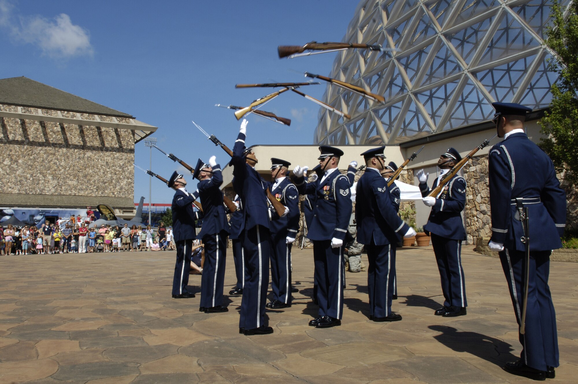 The U.S. Air Force Honor Guard Drill Team throw "Back-to-Backs" during their 12-man routine at Henry Doorly Zoo Aug. 12 in Omaha, Neb. The drill team is the traveling component of the Honor Guard and tours worldwide representing all Airmen while showcasing Air Force precision. (U.S. Air Force photo by Senior Airman Dan DeCook)
