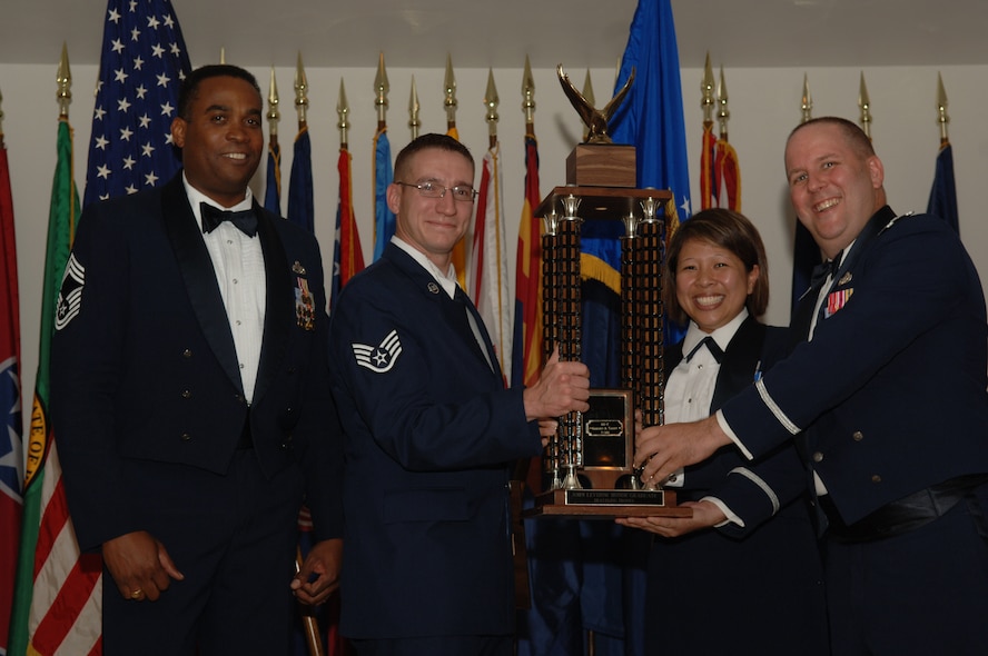 DYESS AIR FORCE BASE, Texas -- Staff Sgt. Gregory Talley, 7th Civil Engineer Squadron explosive ordnance disposal, receives the John L. Levitow Honor Graduate Award from Chief Master Sgt. Jeffery Barnes (left), 7th Equipment Maintenance Squadron, during his graduation from Airman Leadership School in a ceremony at the Heritage Club Aug. 14. Chief Barnes attended to represent the Chief's Group, which sponsors the Levitow Award. Accompanying Sergeant Talley were Master Sgt. Josephine Krieger, 7th CES first sergeant, and Lt. Col. Christopher Duffy, 7th CES commander. The Levitow Honor Graduate Award is presented to the top professional military education graduate from Air Force Airman Leadership Schools. (U.S. Air Force photo/Airman 1st Class Michael Breaux)
