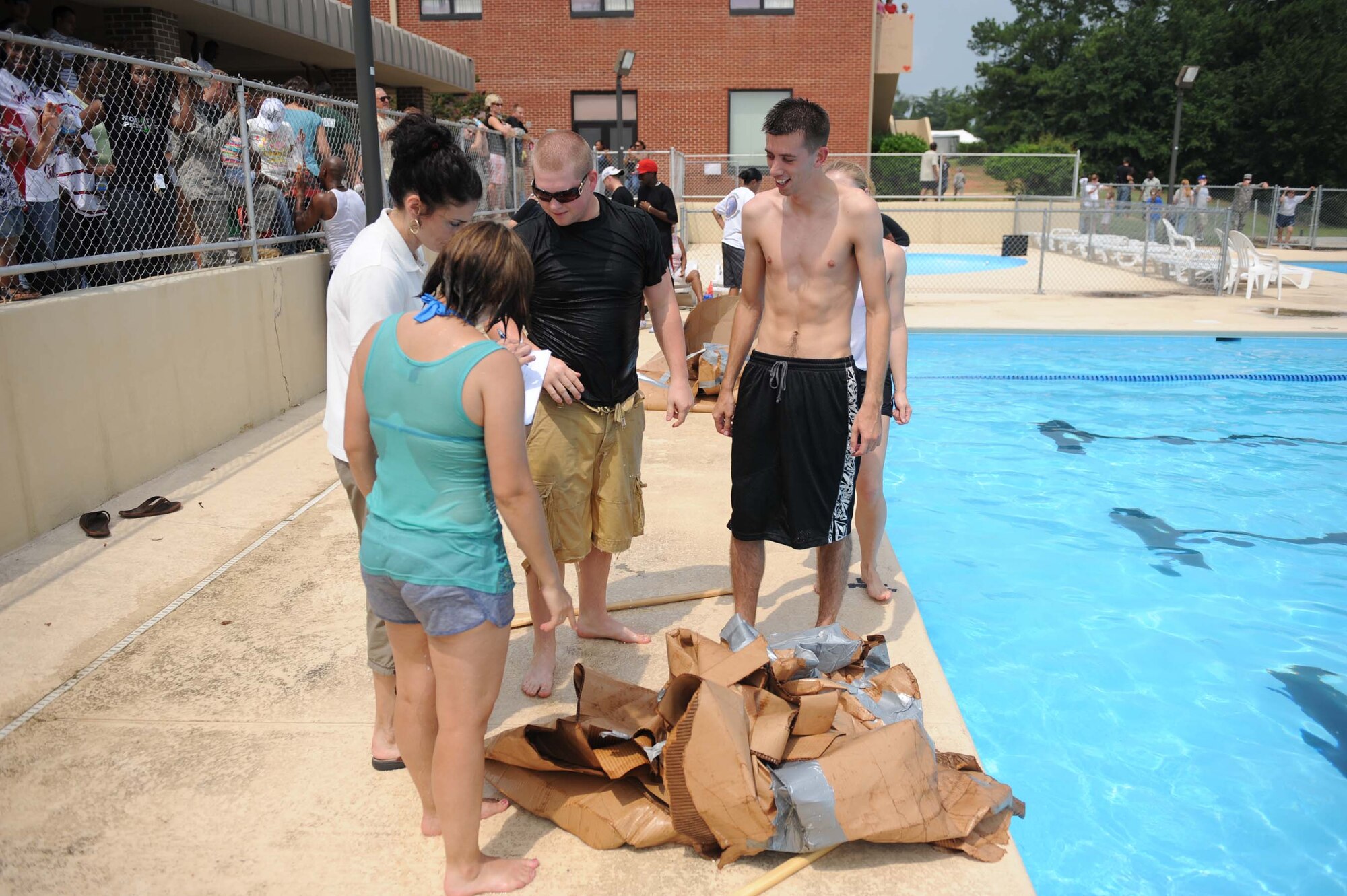 SHAW AIR FORCE BASE, S.C. -- Team "Money Haulers" of the 20th Comptroller Squadron, stand next to their champion pile of cardboard after winning the cardboard boat race for the second consecutive year during the Junior Enlisted Appreciation Day August 15. JEAD is a day full of fun events set aside to show appreciation for the junior enlisted ranks of the Air Force. (U.S. Air Force photo/Staff Sgt. Henry Hoegen)