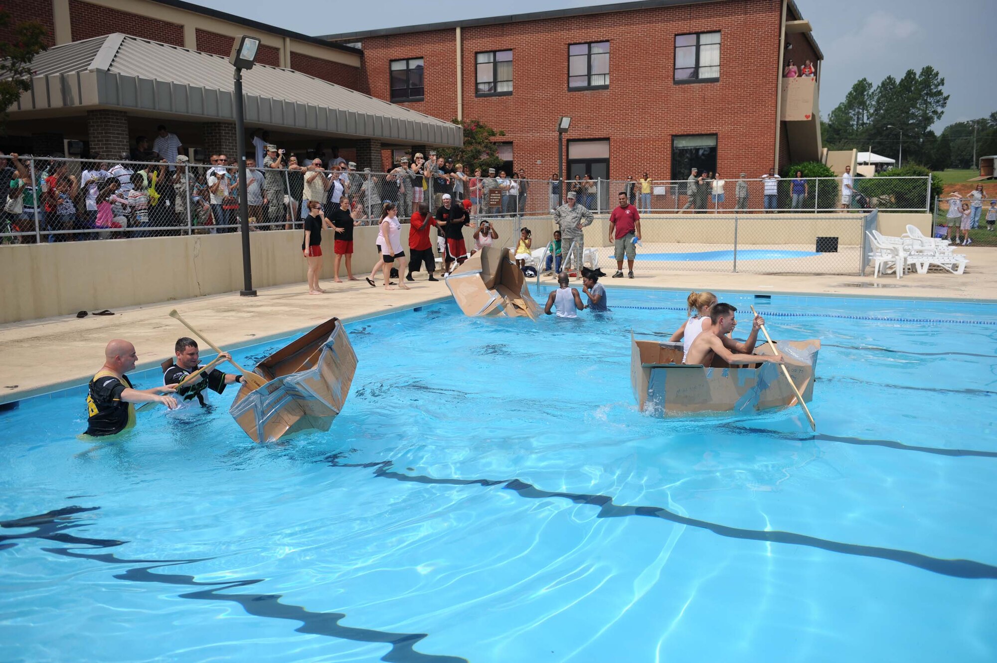 SHAW AIR FORCE BASE, S.C. -- Two boats sink upon entering the pool during the fourth and final heat of the cardboard boat race during the Junior Enlisted Appreciation Day August 15. JEAD is a day full of fun events set aside to show appreciation for the junior enlisted ranks of the Air Force. (U.S. Air Force photo/Staff Sgt. Henry Hoegen)