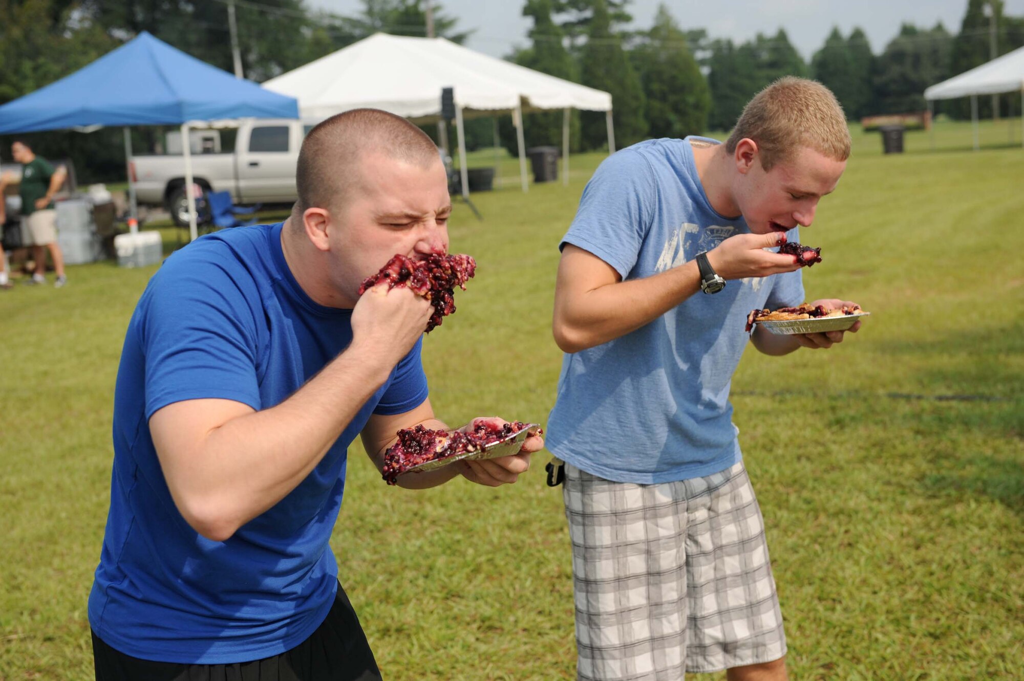 SHAW AIR FORCE BASE, S.C. -- Staff Sgt. Dustin Mixon (left), 20th Civil Engineering Squadron, forces down the last bits of his pie in a win against Airman Phillip Collar, 20th Fighter Wing Legal Office, during the pie eating contest held as part of the Junior Enlisted Appreciation Day festivities August 15. JEAD is a day full of fun events set aside to show appreciation for the junior enlisted ranks of the Air Force. (U.S. Air Force photo/Staff Sgt. Henry Hoegen)