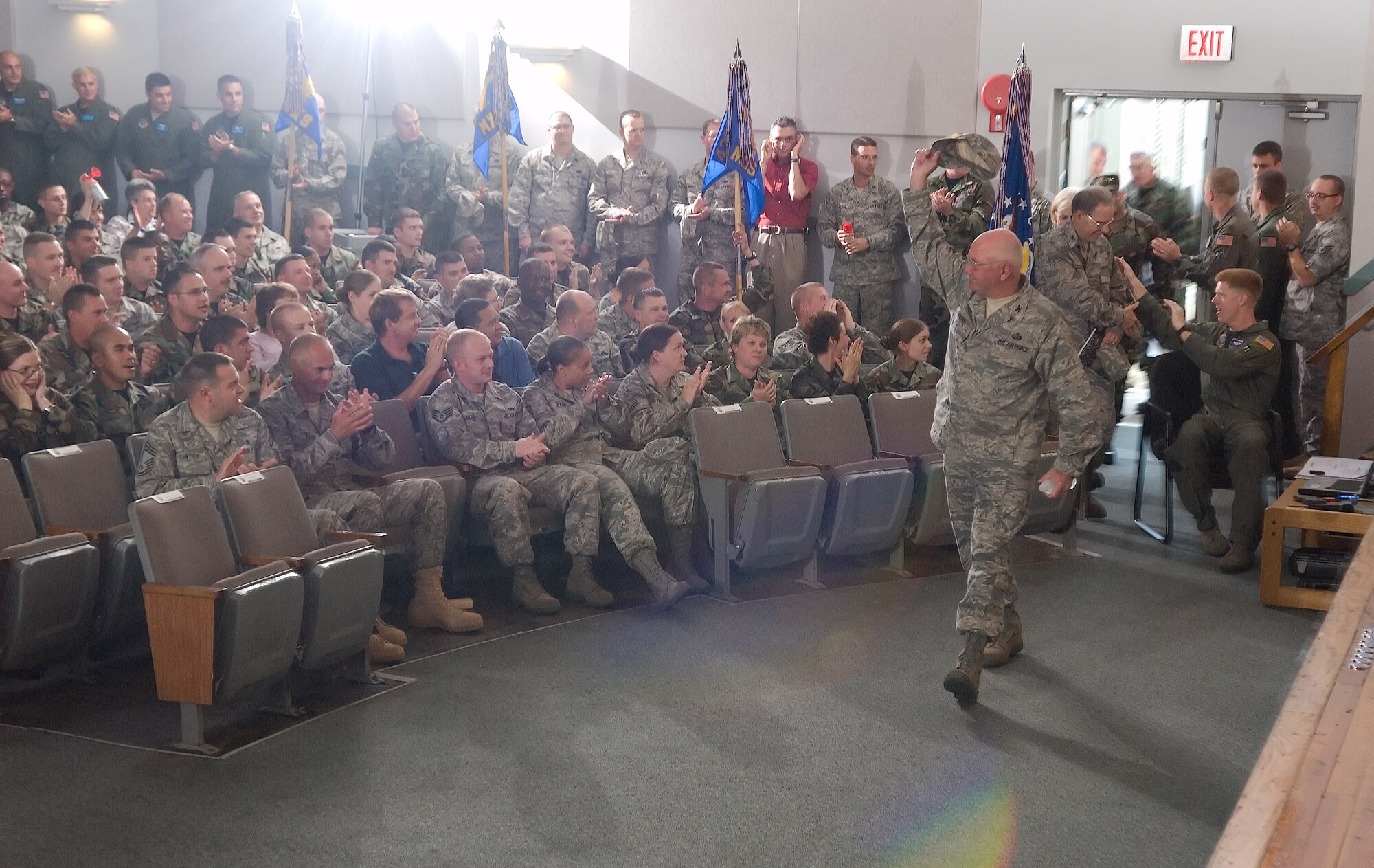 DOVER AIR FORC E BASE, Del. -- Team Dover Airmen cheer as Team Dover leadership entered the operational readiness inspection out-brief Aug. 14 at the Base Theater. Team Dover received an "Excellent" for their recent ORI in Alpena, Mich. (U.S. Air Force photo/ Jason Minto) 