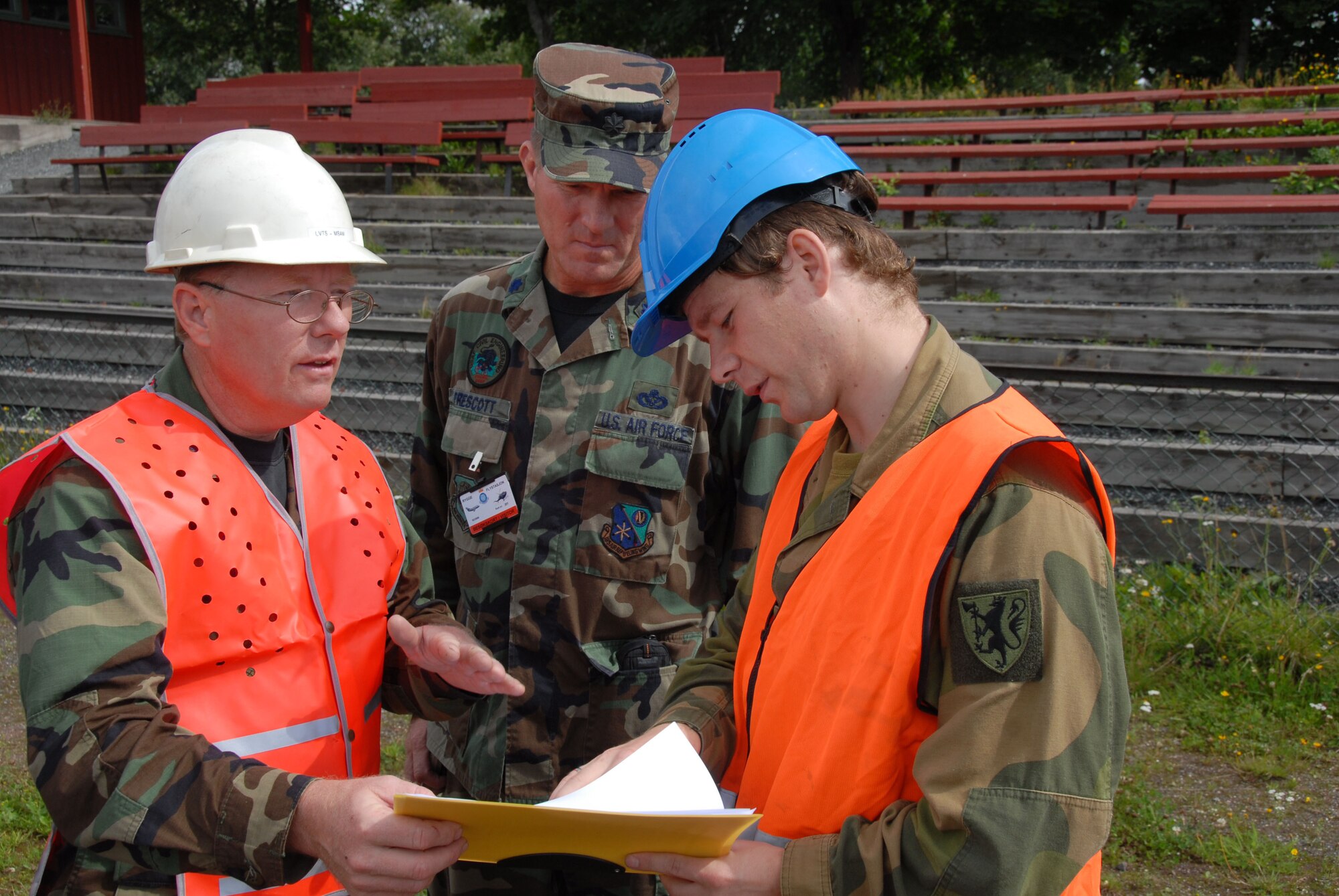 August 11, 2008 Rygge, Air Force Base, Norway- 

Lt Col William Phillips, Operations Officer for Civil Engineering (CE) Squadron, Lt Col Gary Prescott Commander of CE, and a Norwegian Army Cadet, 2nd Lt Rune Stenberg, of the Norwegian Military Academy, Discuss plans for the construction of a soccer field to be used for military and community use. Members of the Iowa Air National Guard, 185th Air Refueling Wing, Civil Engineering Squadron, in Sioux City, Iowa, deployed for training to Rygge Air Force Base, Norway, in support of Operation Impeccable Glove 2008. The engineering mission is a joint effort with the, Army Cadets, from the Norwegian Military Academy, at Rygge Air Force Base, Norway.

Official Air Force Photo By: SSgt. Oscar M. Sanchez-Alvarez
