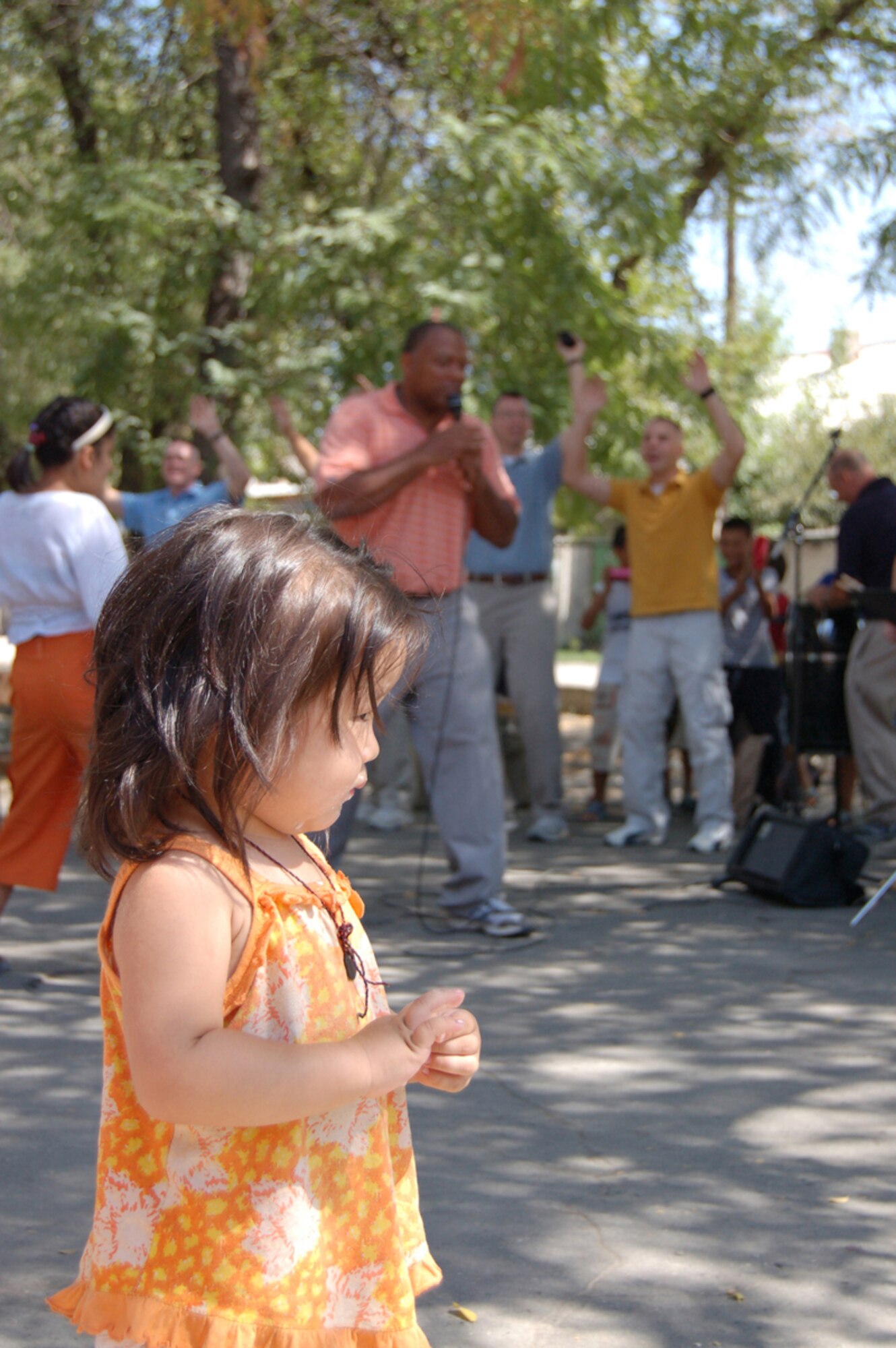 MANAS AIR BASE, KRYGYZ REPUBLIC--A young Kyrgyz girl enjoys the performance of the Air Forces Central Band "Sirocco" at the Najesda Center Orphanage in the Kyrgyz Republic Capitol of Bishkek. The band was on a ten day tour to Manas AB where they played at eight schools, villages and orphanages as well as at the U.S. Embassy and on base. (Air Force photo / Senior Master Sgt. Patrick J. McCracken)