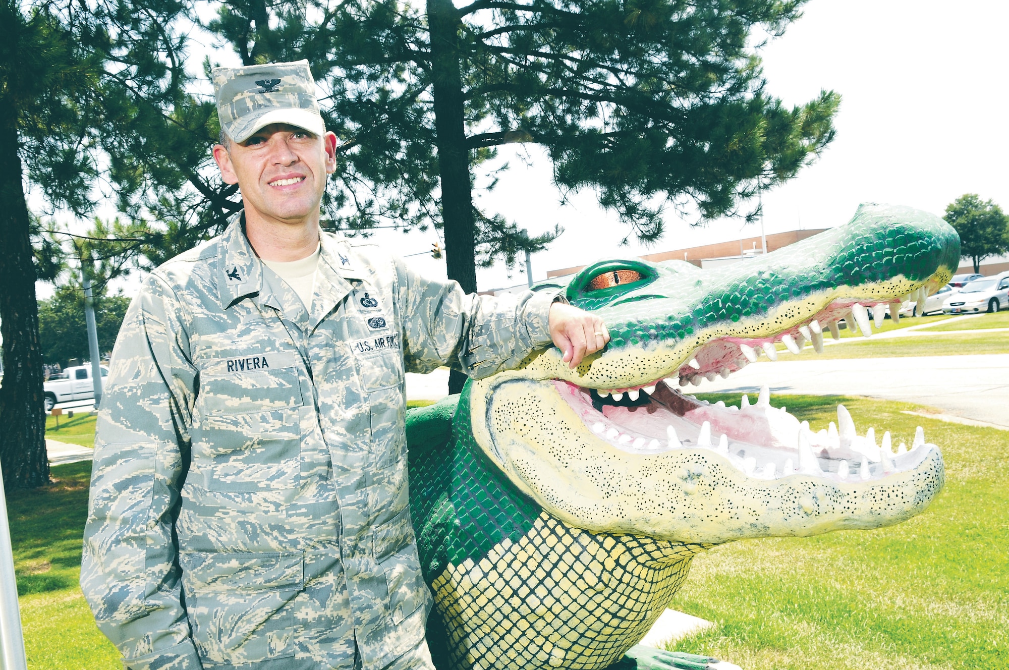 Col. Jose Rivera, 5th Combat Communications Group commander, poses with the group’ s mascot. The colonel took command of the group July 18. U.S. Air Force photo by Sue Sapp 