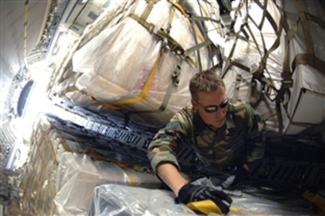 U.S. Air Force Staff Sgt. Chris Droegemueller searches for a pallet containing medical supplies within the second shipment of U.S.-donated humanitarian aid to Georgia, Aug. 14, 2008. Droegemueller is an aerial transporter assigned to the 86th Contingency Response Group on Ramstein Air Base, Germany. 