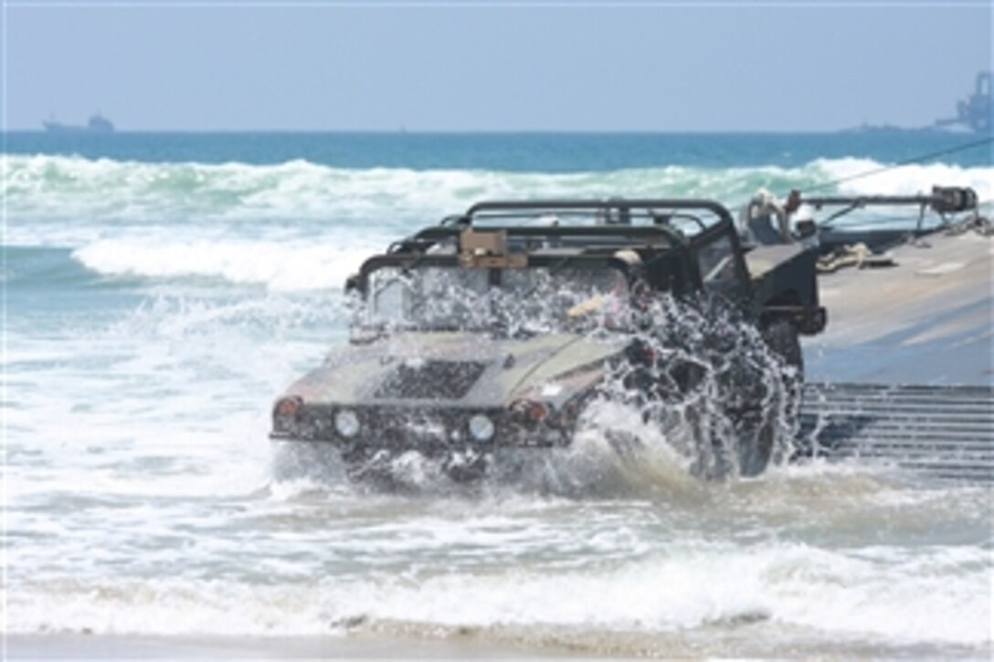 U.S. Army soldiers offload a Humvee from a floating causeway during a Joint Logistics Over-The-Shore exercise at Red Beach, Camp Pendleton, Calif., on July 24, 2008.  The exercise is a joint military operation aimed at preparing units for amphibious assault landings in friendly and unfriendly situations.  